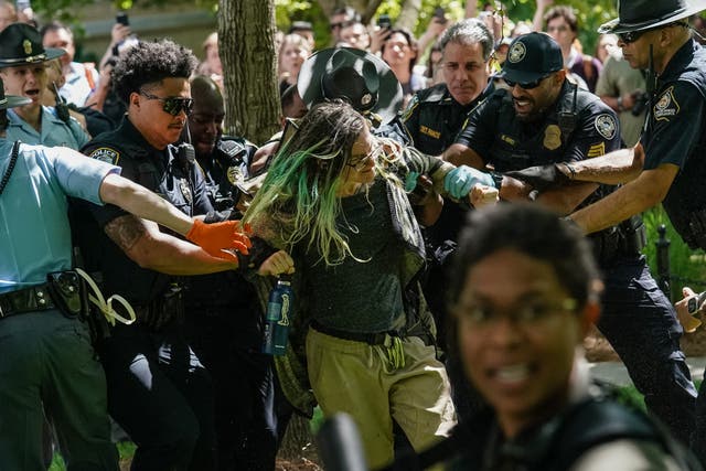 Police officers arrest a demonstrator during a pro-Palestinian protest against the war in Gaza at Emory University on April 25, 2024, in Atlanta, Georgia. College campuses across the US braced for fresh protests by pro-Palestinian students, extending a week of increasingly confrontational standoffs with police, mass arrests and accusations of anti-Semitism