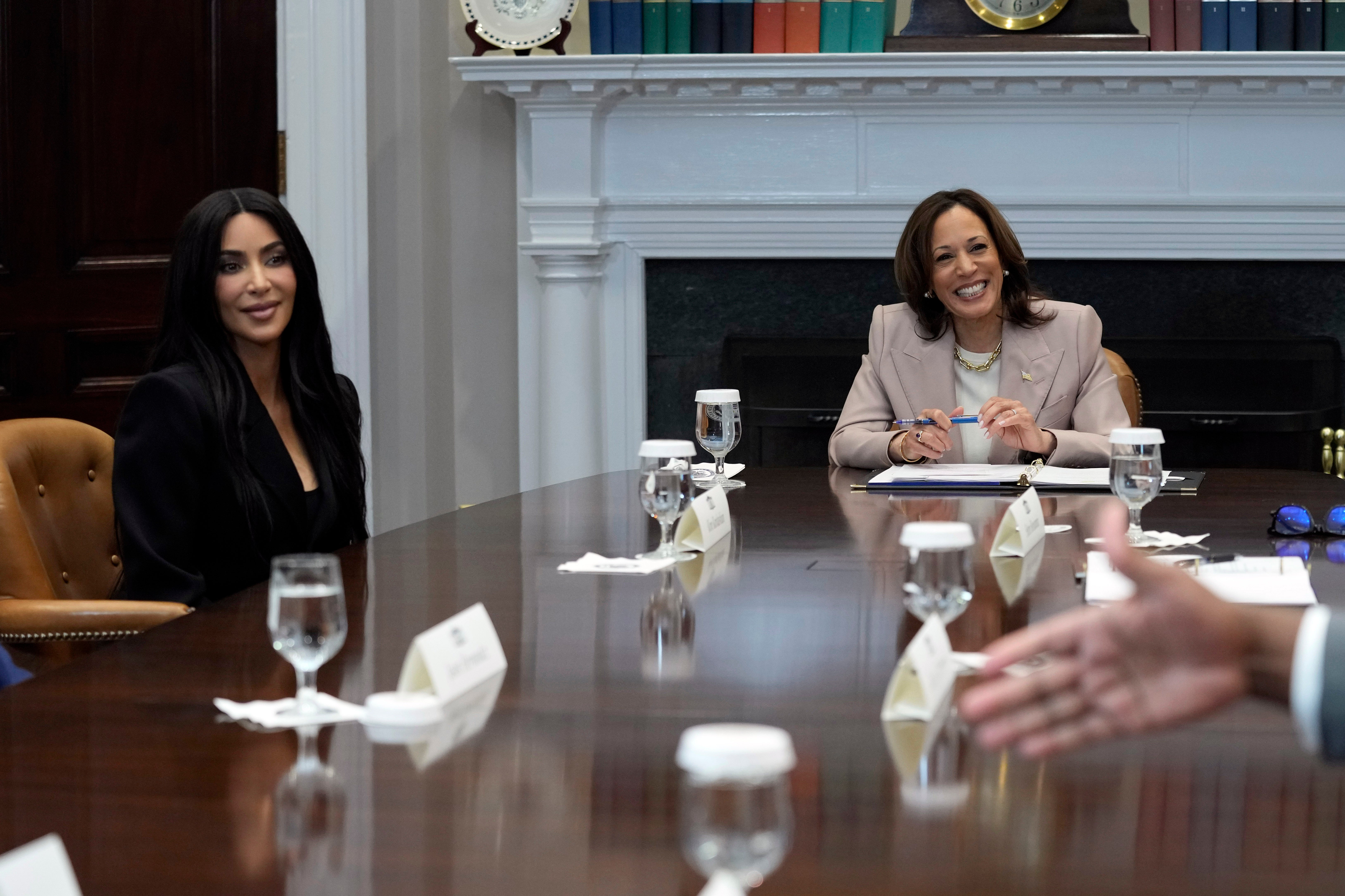 Vice President Kamala Harris and Kim Kardashian listen during a discussion in the Roosevelt Room of the White House in Washington on 25 April 2024