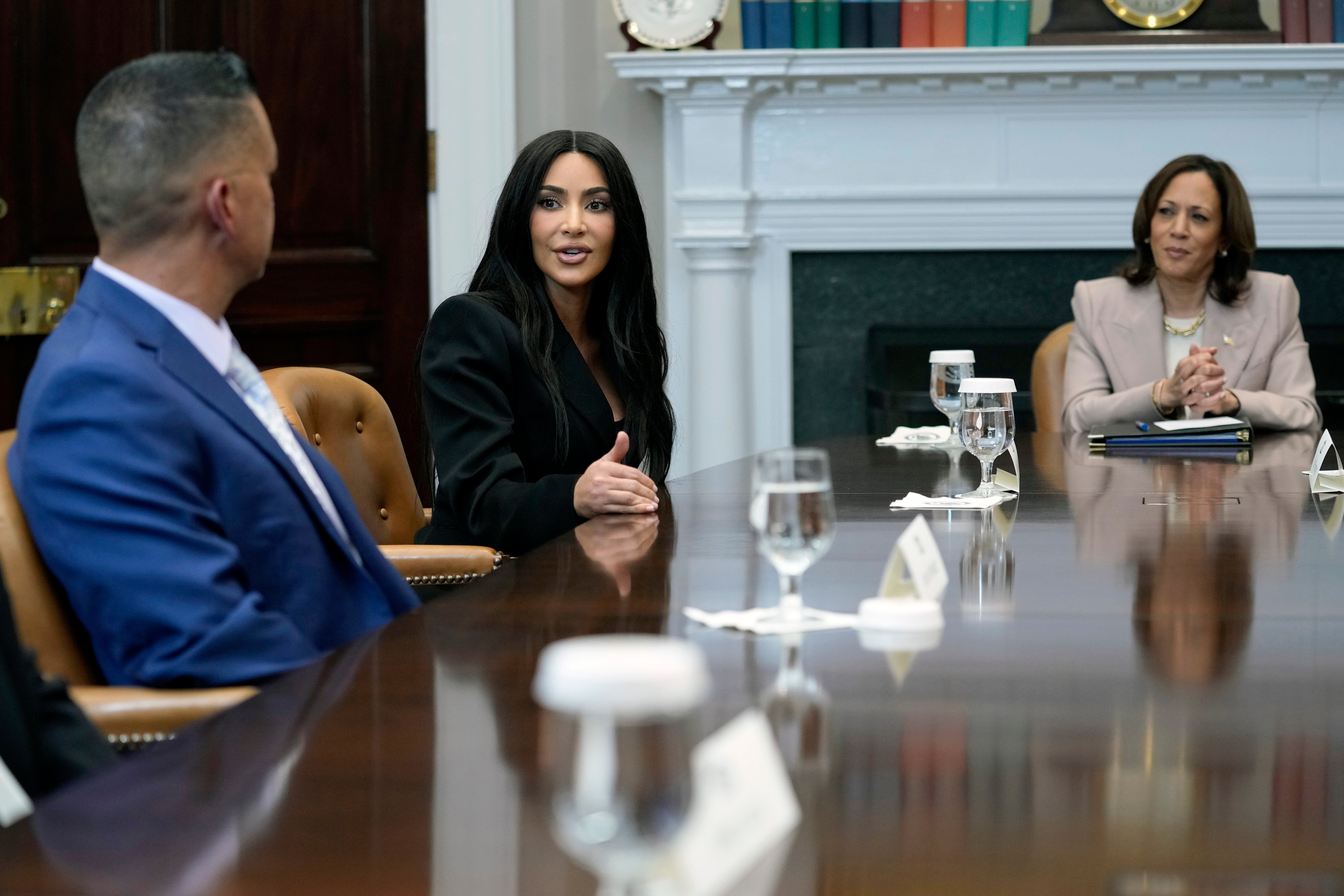 Vice President Kamala Harris listens as Kim Kardashian speaks during a discussion in the Roosevelt Room of the White House in Washington, on 25 April 2024