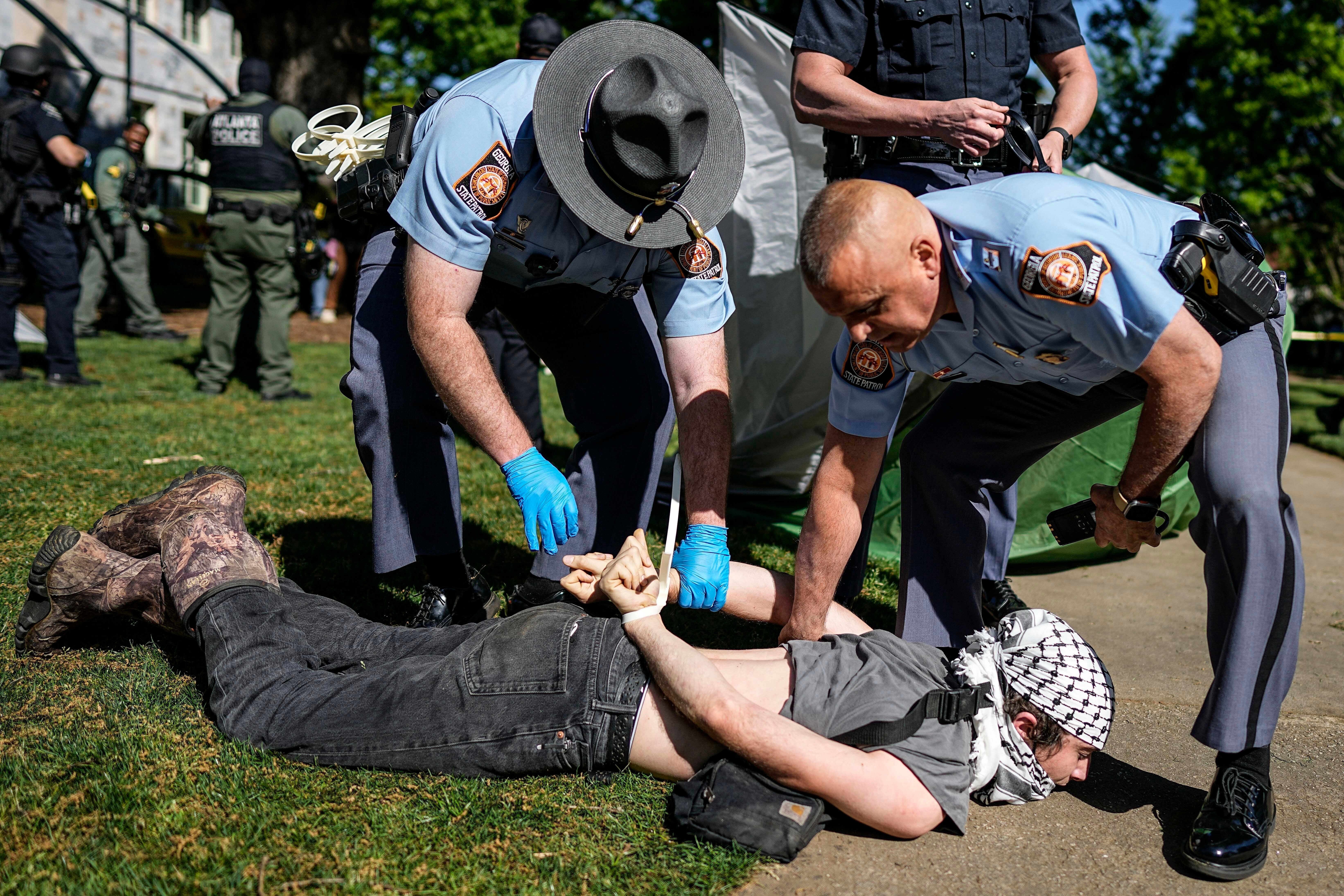 Georgia state officials detain a protester at Emory University