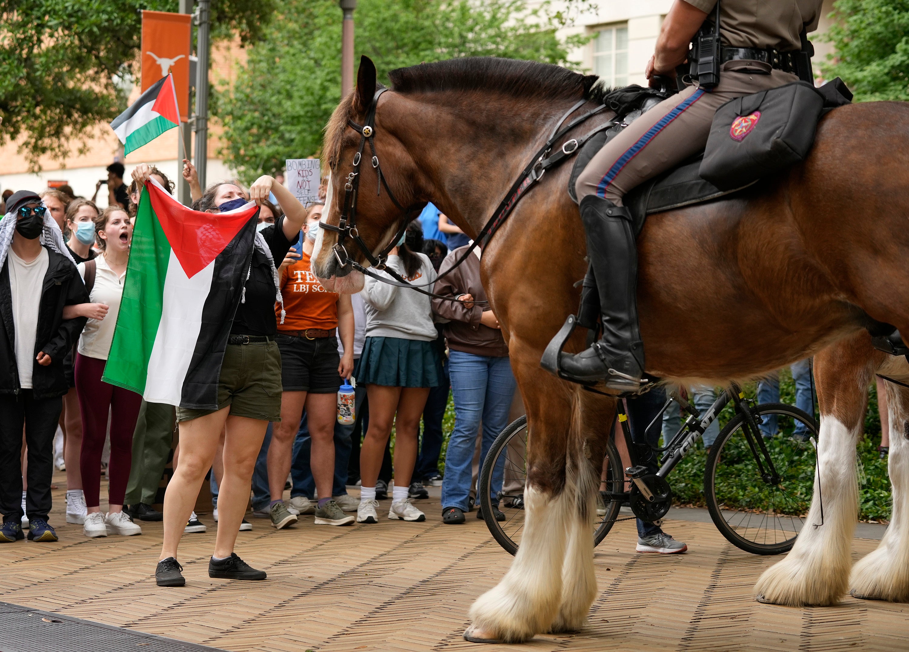 Cally, a former UT student, faces off with a mounted state trooper at a pro-Palestinian protest at the University of Texas, Wednesday, April 24, 2024, in Austin