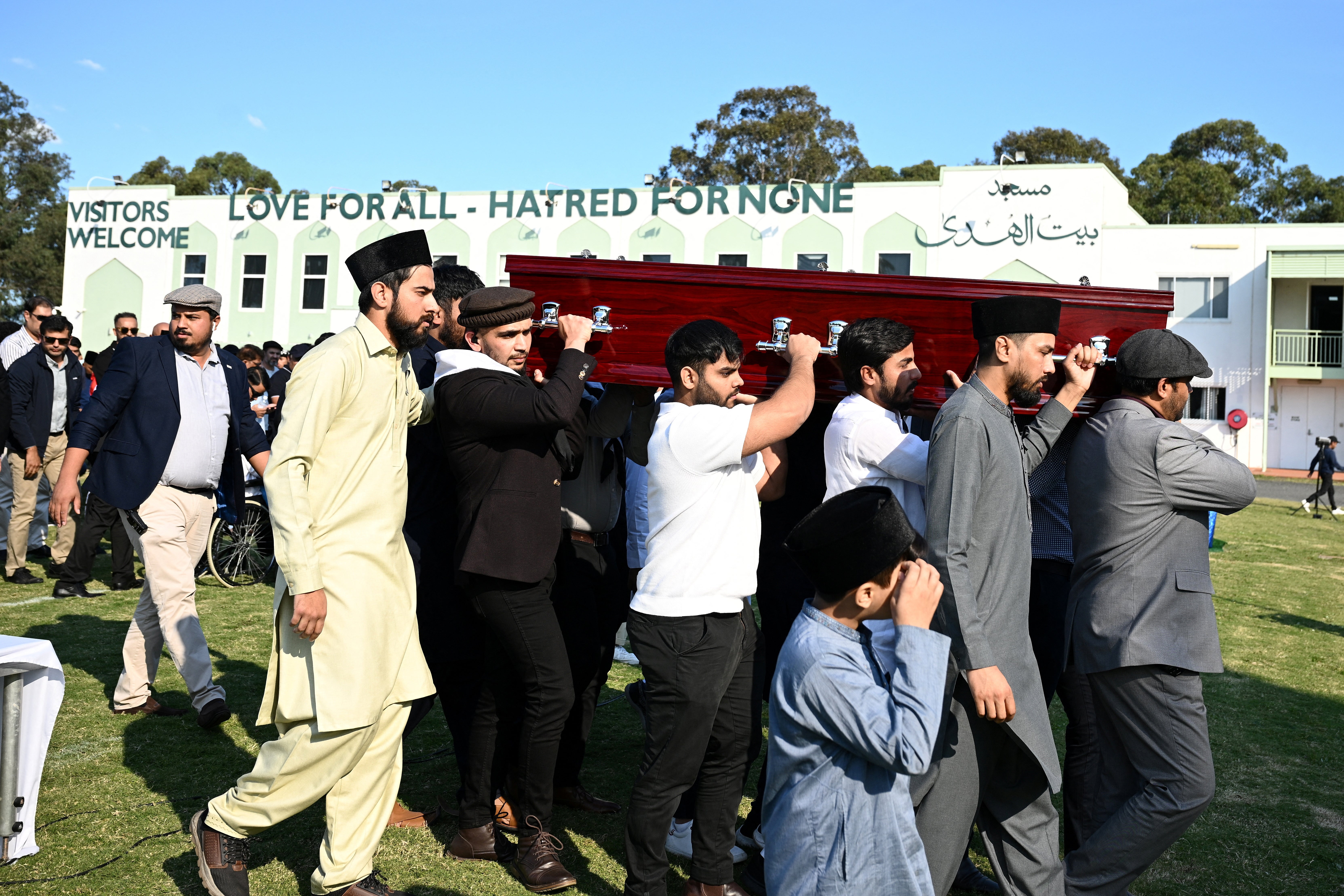 A casket is carried during the funeral for Faraz Tahir at Masjid Baitul Huda mosque in Sydney, Australia
