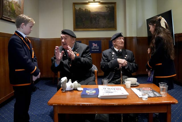 WW2 veterans Richard Aldred (left), 99, and Stan Ford (right), 98, meeting school children at a D-Day memorial event. (Gareth Fuller/PA)