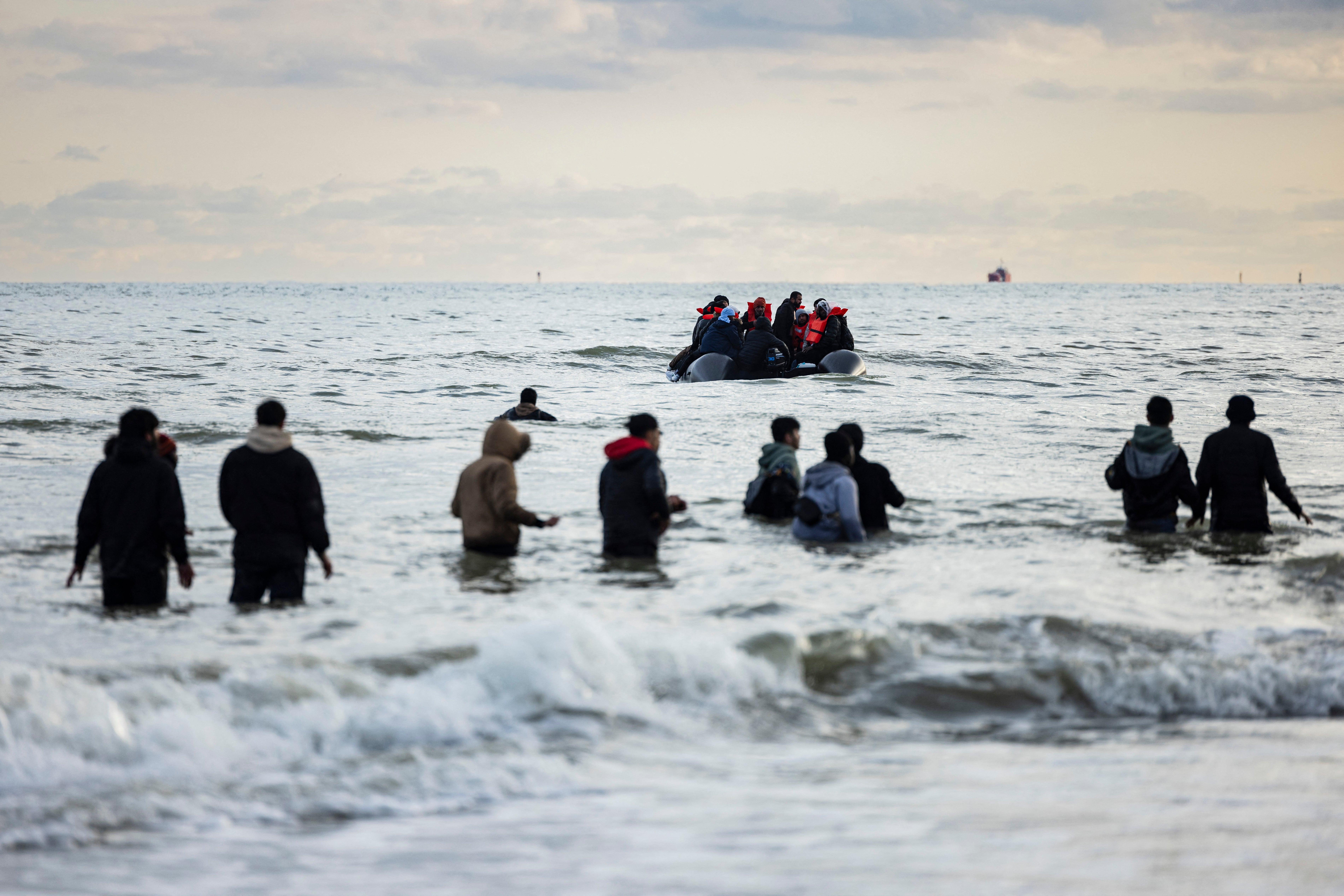 Migrants board a smuggler's boat on the beach at Gravelines, near Dunkirk,
