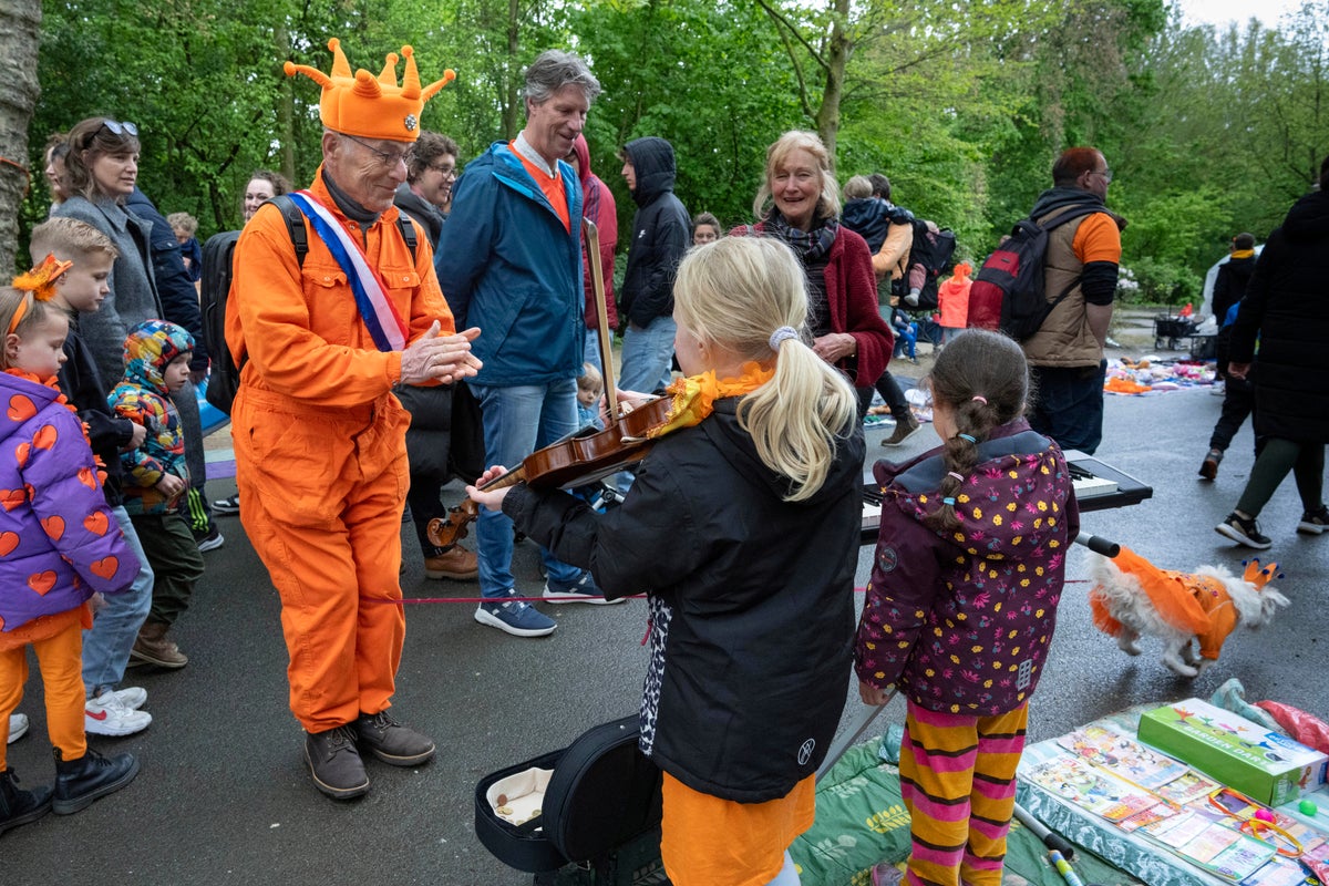 Orange crush: Boats packed with revelers tour Amsterdam canals celebrating the king’s birthday