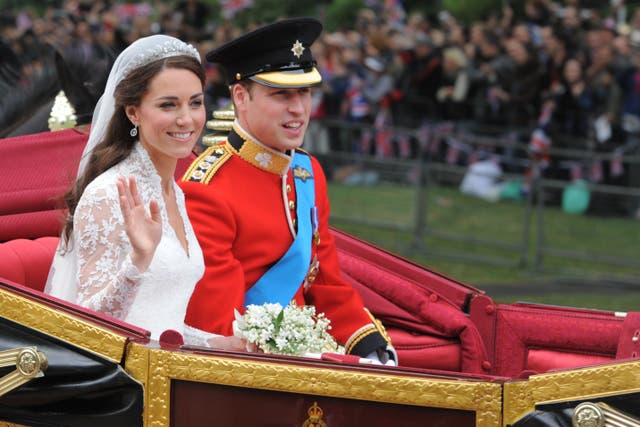 Kate and William travel in the 1902 State Landau along the processional route to Buckingham Palace after their wedding (Dimitar Dilkoff/PA)