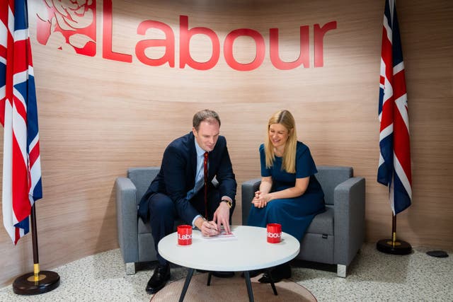 Dr Dan Poulter signing his Labour Party membership form with Ellie Reeves, Labour’s deputy national campaign co-ordinator (Labour Party/PA)