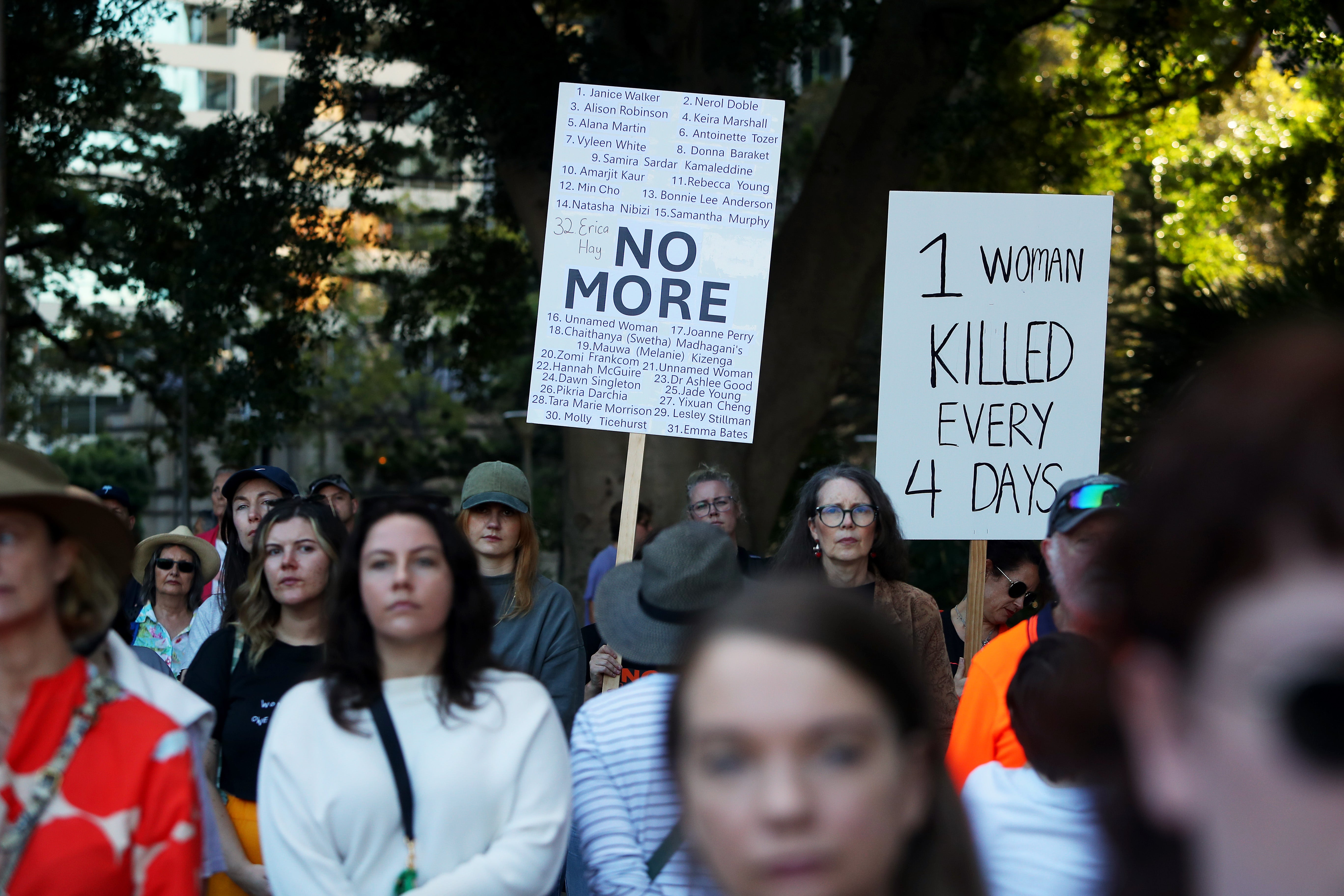 Demonstrators hold placards at rally in Sydney