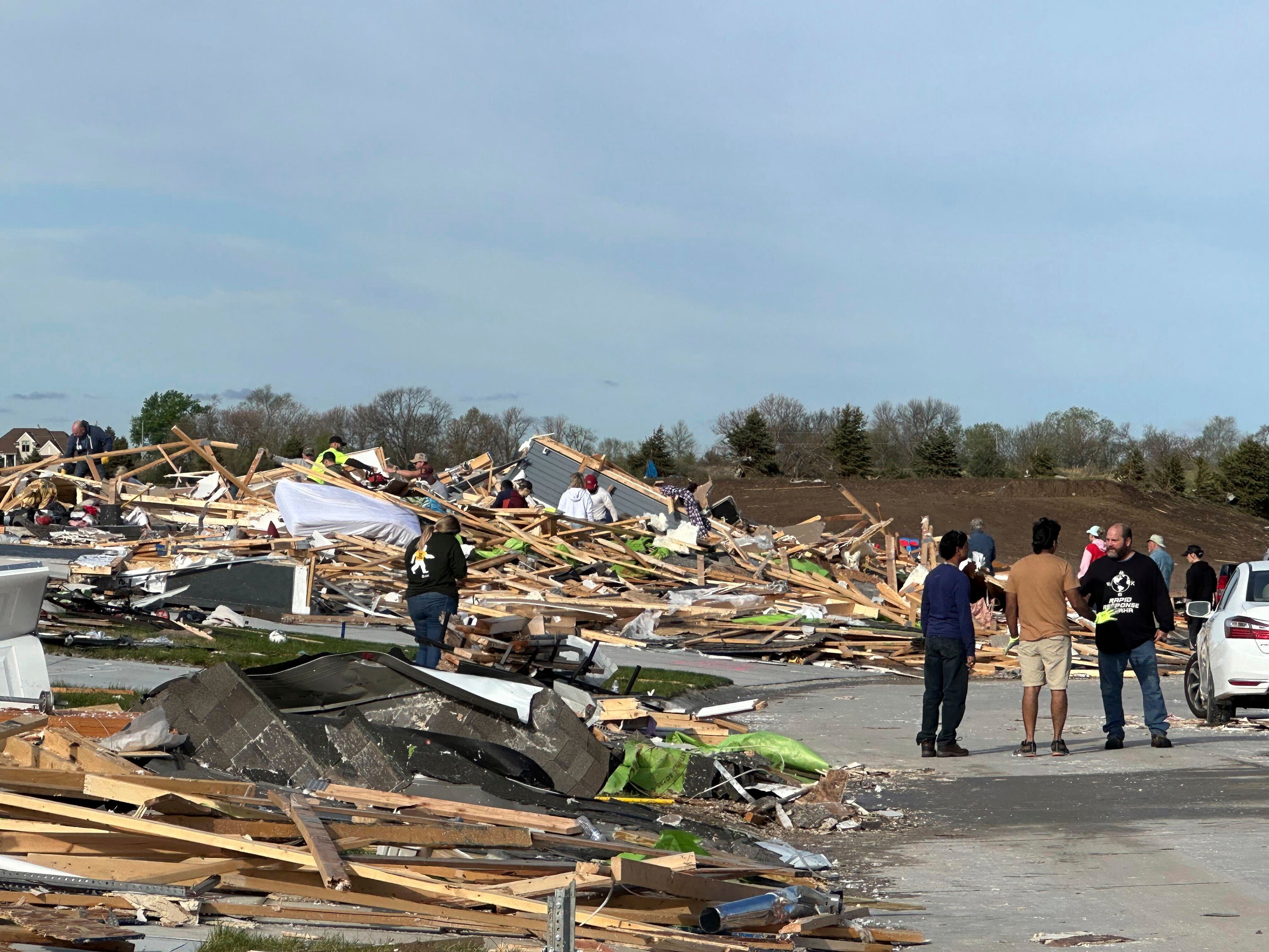 People dig through the rubble in Elkhorn following the tornado on Thursday 25 April 2024