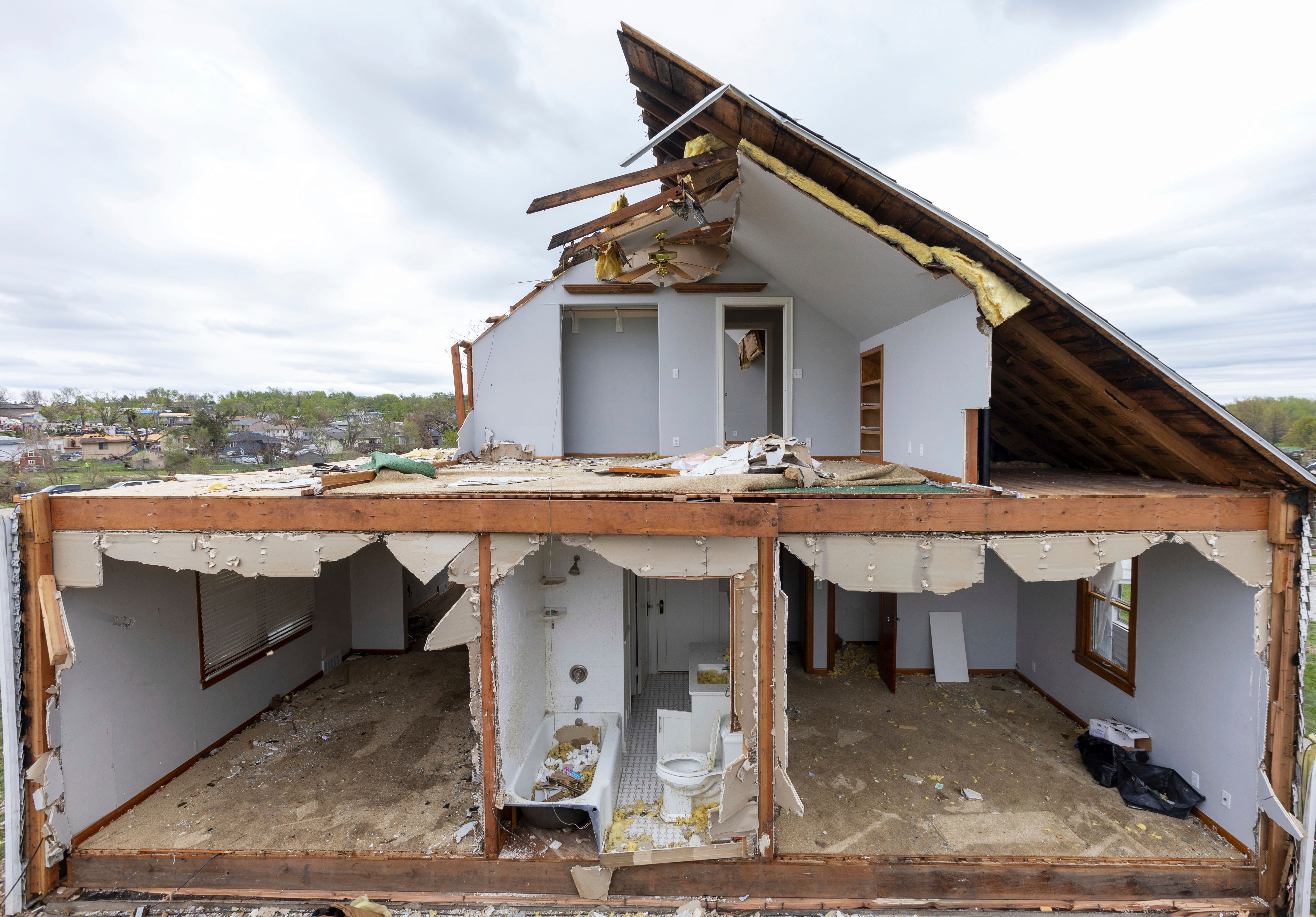 A partially torn off roof is seen on a damaged home in Omaha on 27 April