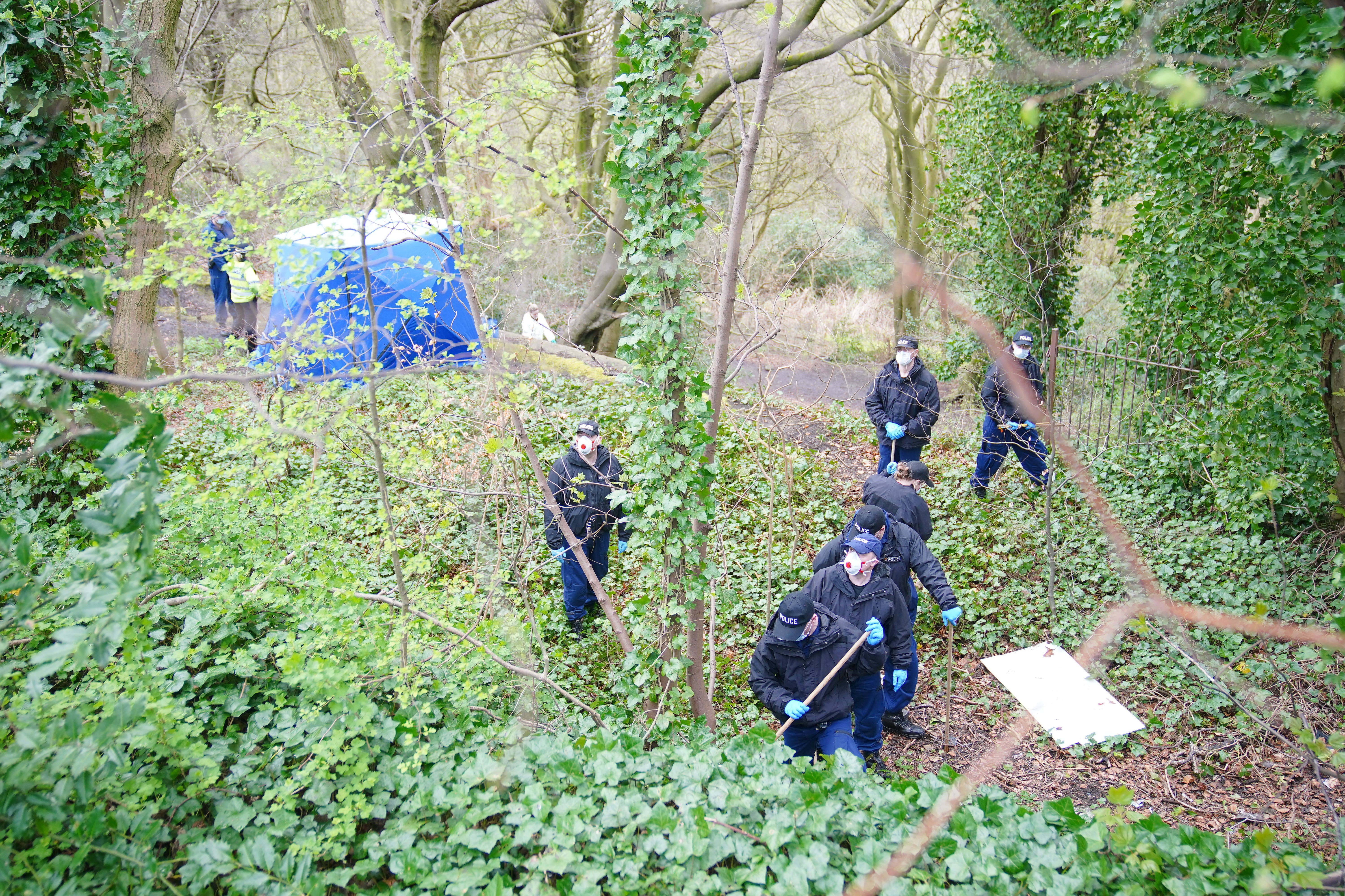Police officers by a forensic tent at Kersal Dale, near Salford, Greater Manchester, where a major investigation has been launched