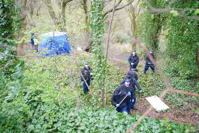 <p>Police officers by a forensic tent at Kersal Dale, near Salford, Greater Manchester, where a major investigation has been launched</p>