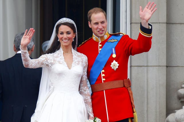 Prince William and his wife Kate wave to the crowds from the balcony of Buckingham Palace following their wedding at Westminster Abbey (PA)