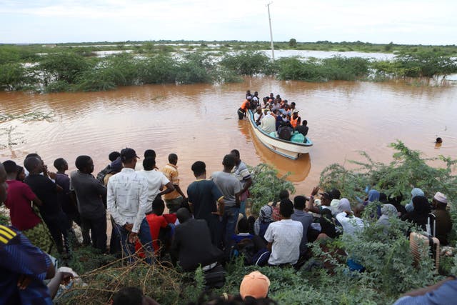 <p>People cross a flooded area at Mororo, border of Tana River and Garissa counties, North Eastern Kenya</p>
