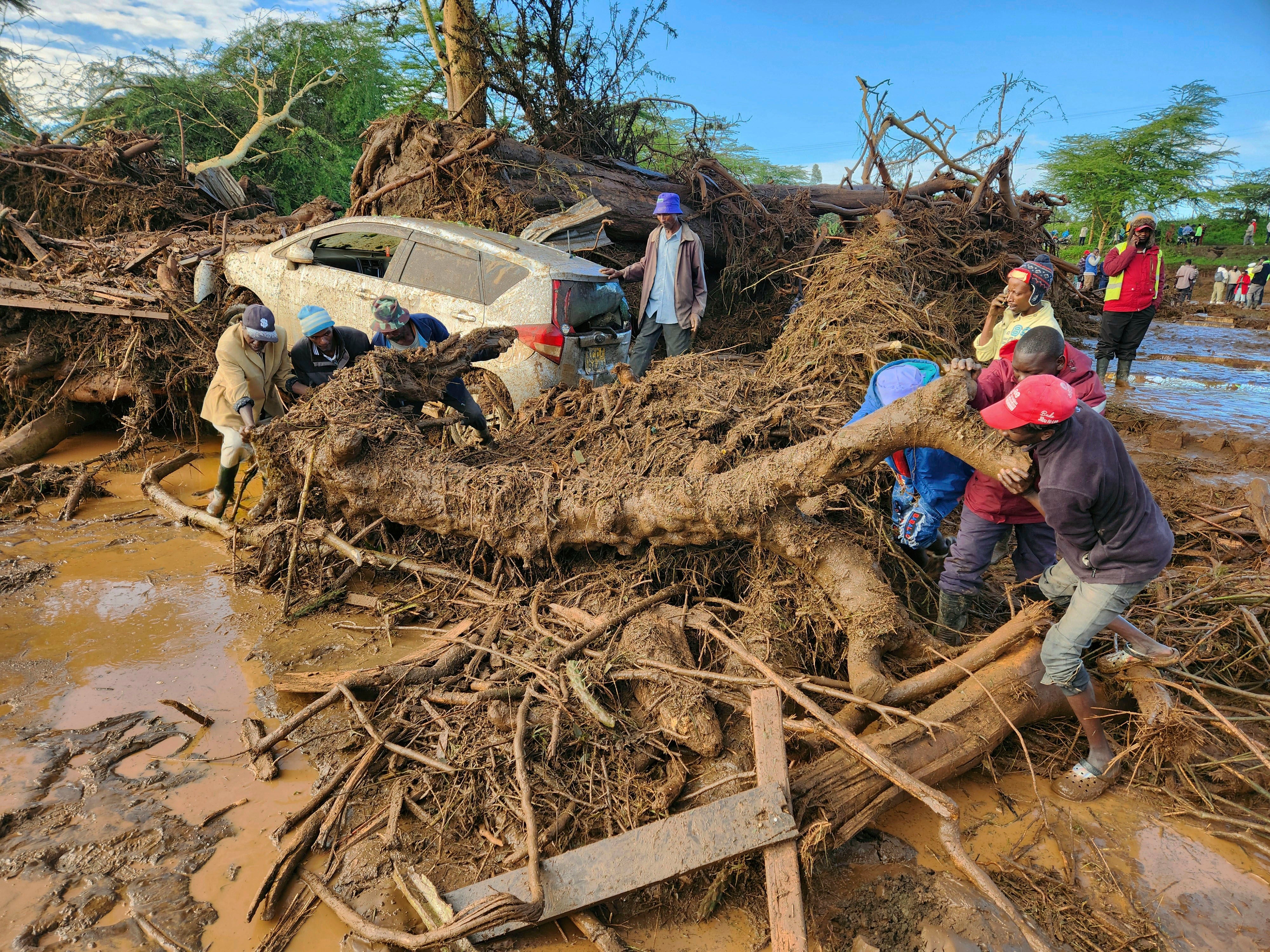 People try to clear the area after a dam burst, in Kamuchiri Village Mai Mahiu, Nakuru County, Kenya