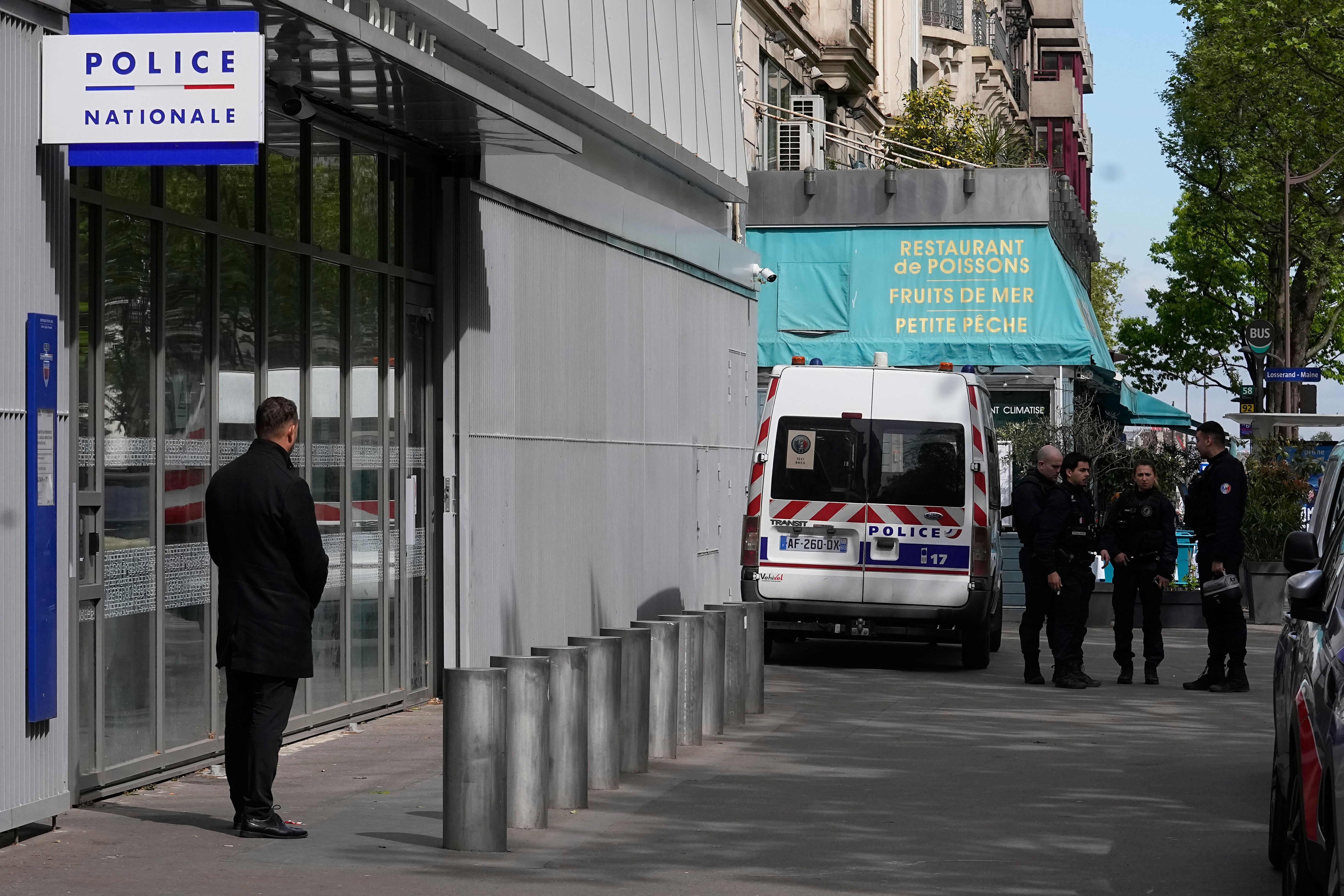 Police officers stand outside the police station where French actor Gerard Depardieu is expected to be questioned
