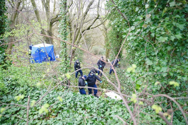 Police officers search by a forensic tent at Kersal Dale, near Salford, Greater Manchester (Peter Byrne/PA)