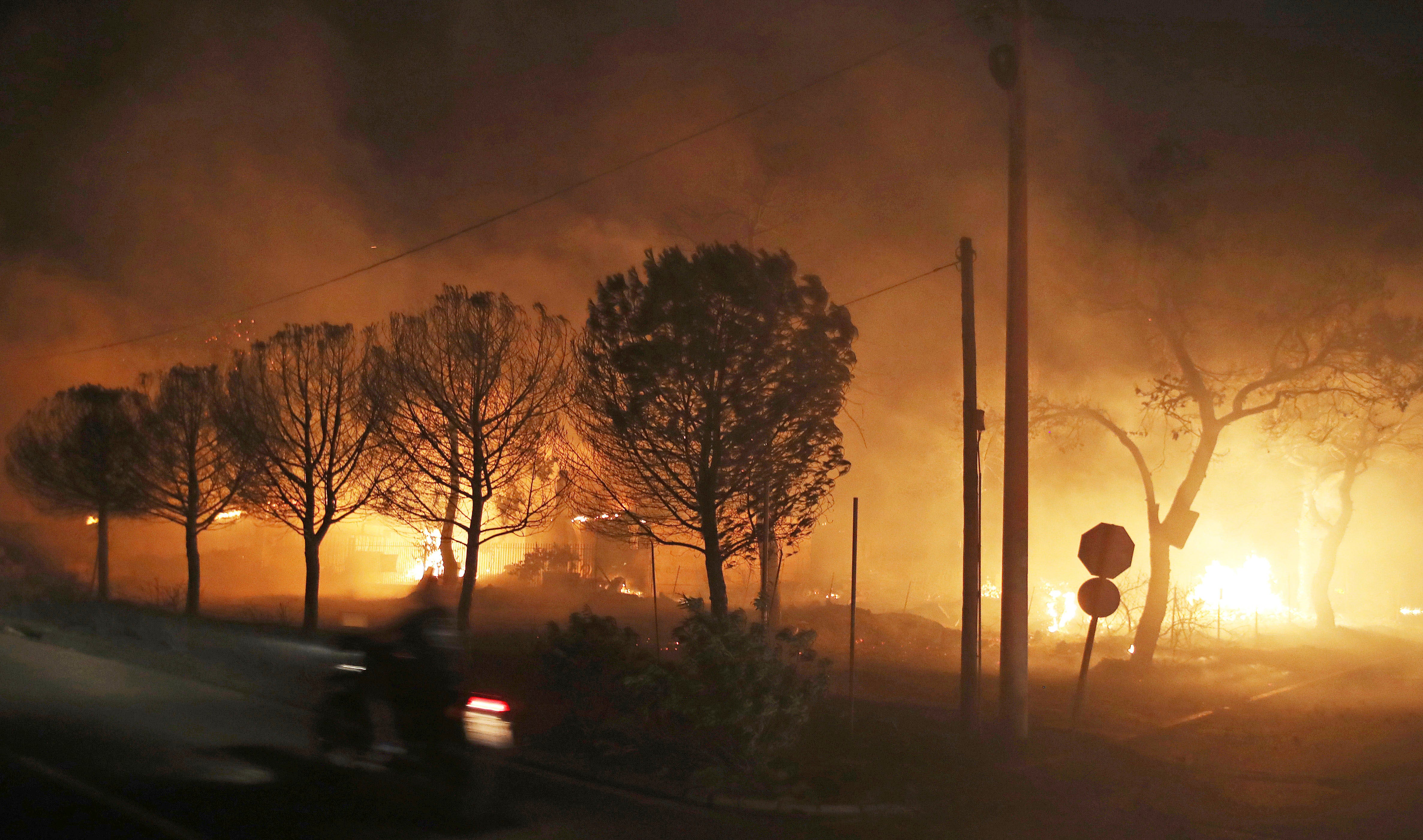 Buildings burn in the town of Mati, east of Athens, Greece