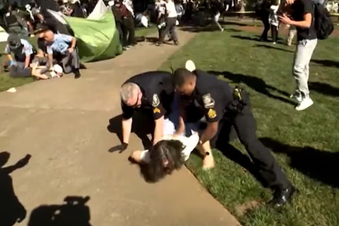 A woman, believed to be Caroline Fohlin, was restrained by police officers during pro-Palestine protests at Emory University last Thursday