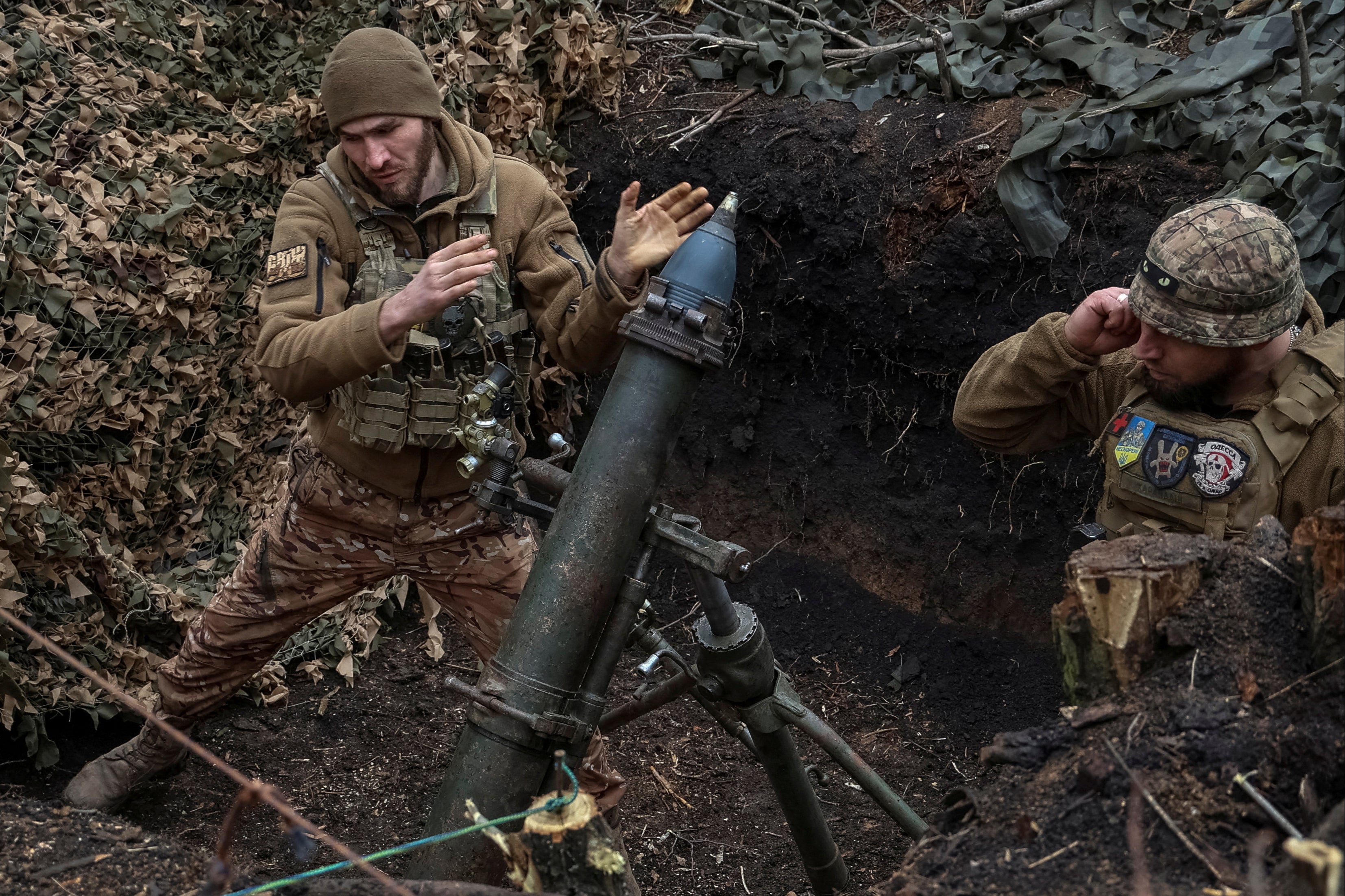 Ukrainian servicemen of the 28th Separate Mechanised Brigade fire a 120-mm mortar towards Russian troops in Donetsk