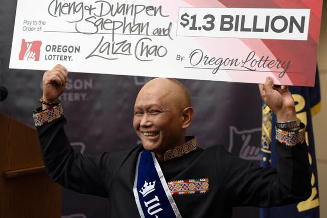 <p>Powerball winner Cheng ‘Charlie’ Saephan celebrates his win at a news conference in Oregon</p>