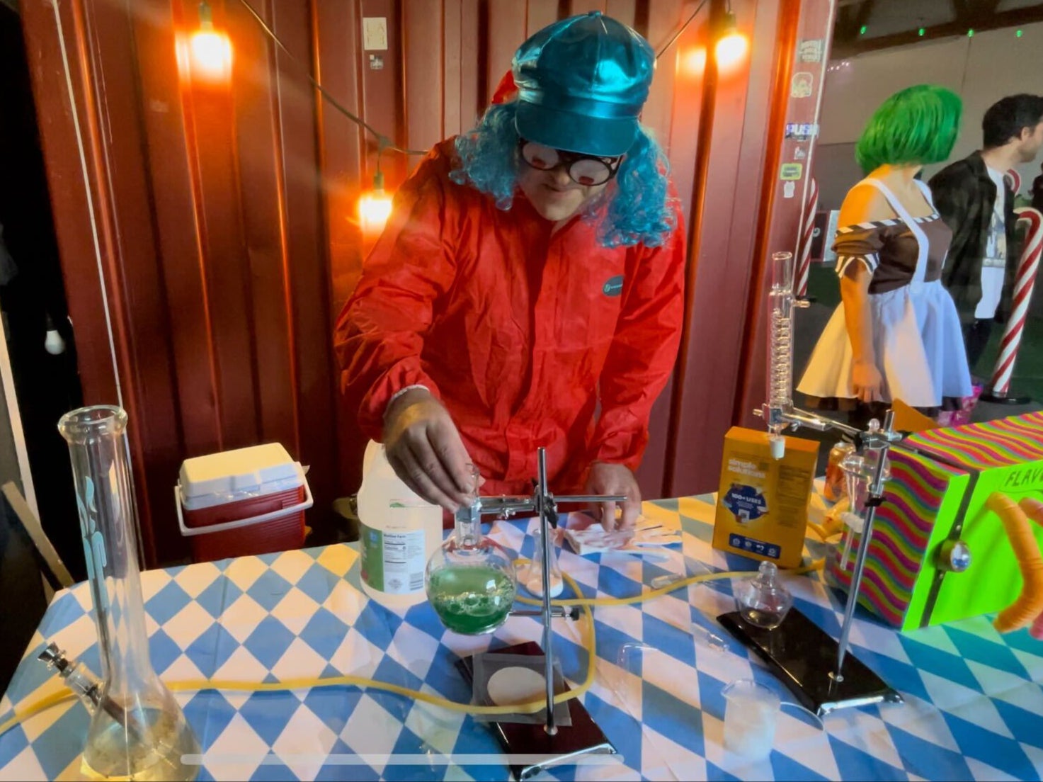The head Oompa Loompa creates a concoction with lab tools and a bong at the Willy Wonka Experience in Downtown Los Angeles, California on 28 April.