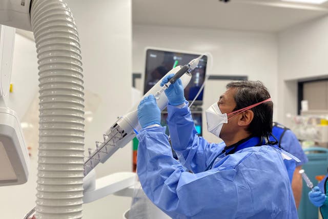 Professor Pallav Shah guiding a catheter through a robotic arm to the site of the suspected cancerous nodule (Royal Brompton Hospital/PA)