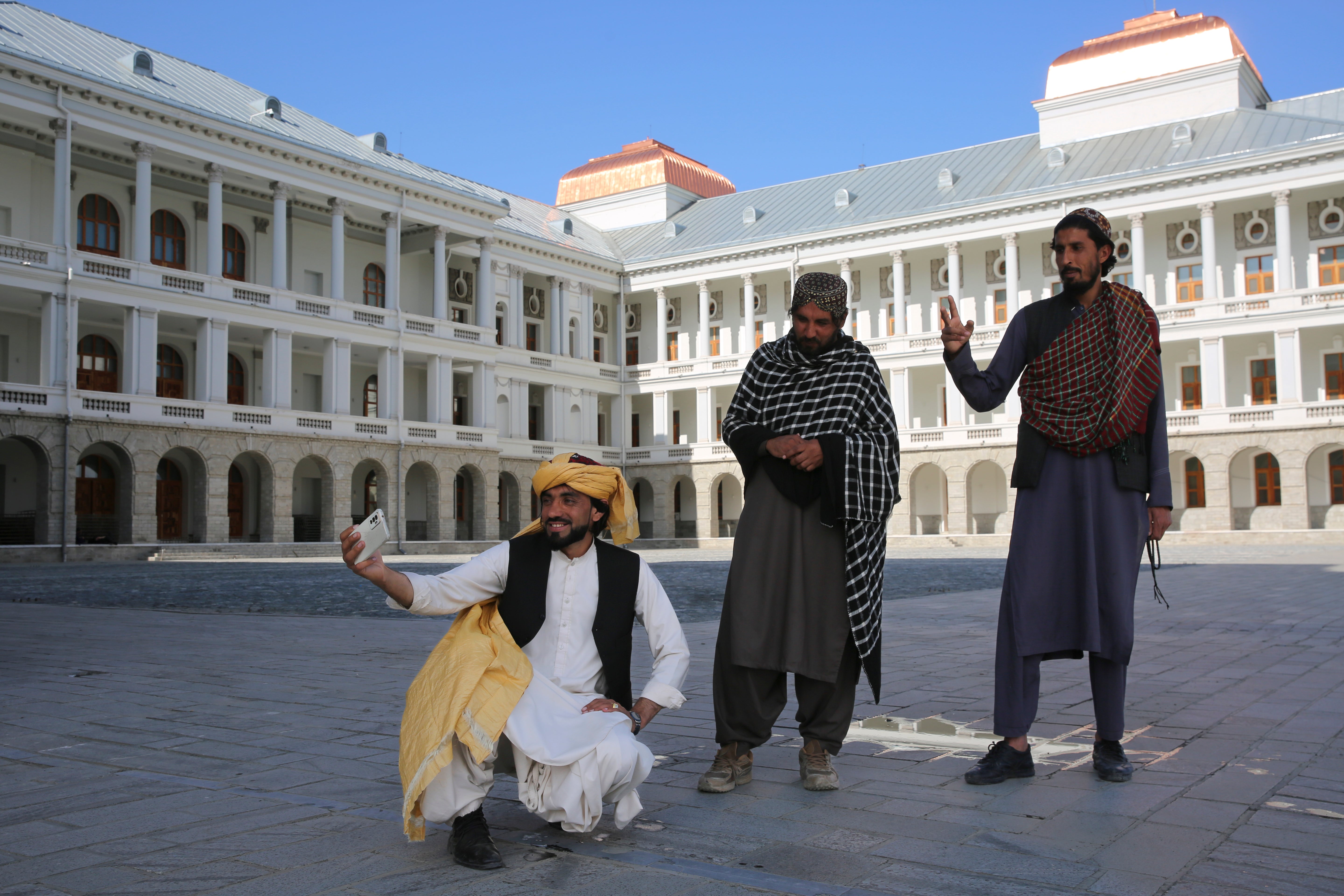 Afghans take selfies at the renovated Darul Aman Palace in Kabul, Afghanistan, Wednesday, April 24, 2024