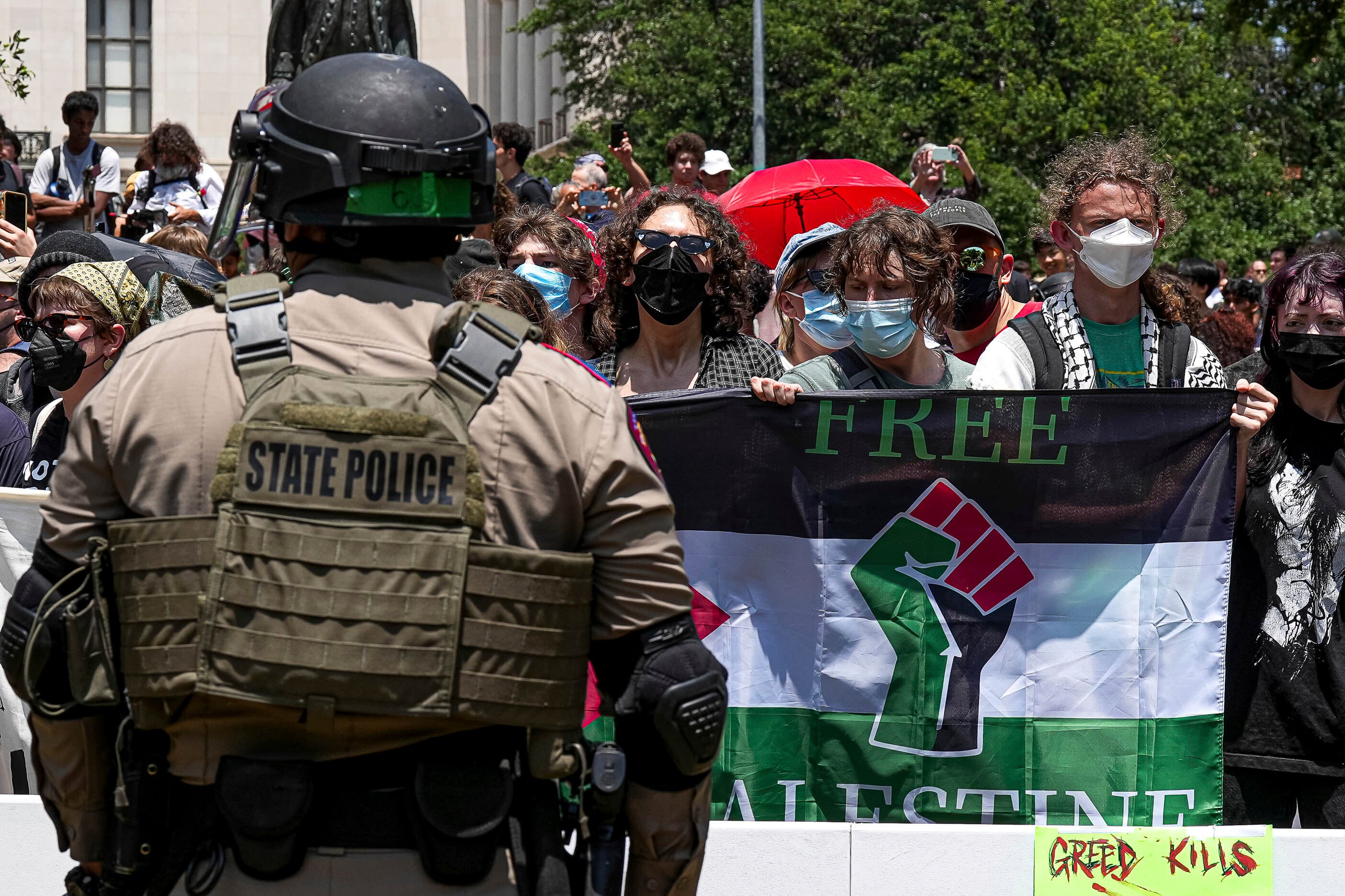 Pro-Palestinian protesters stand with linked arms surrounded by Texas state troopers and police at an encampment at the University of Texas, Austin on 29 April. Officials have made dozens of arrests at the school in recent days