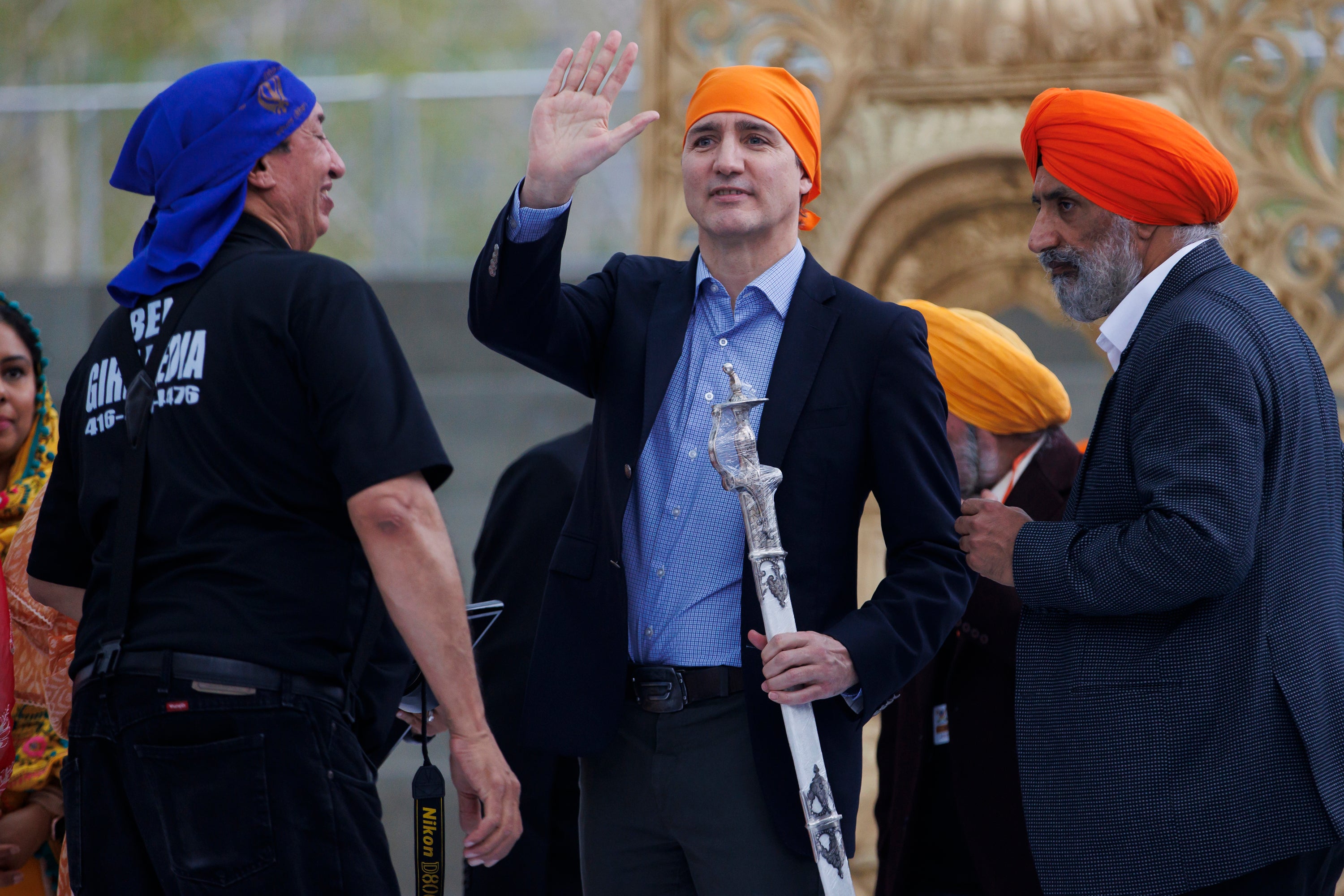 Canadian prime minister Justin Trudeau waves to the crowd after receiving the gift of a ceremonial sword from Sikhs in Ontario