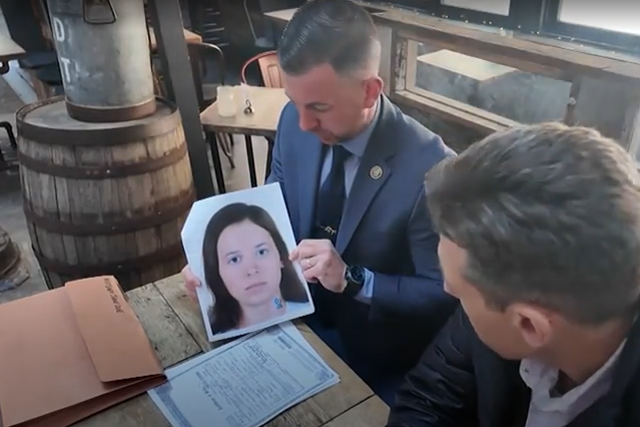 <p>Detective Ryan Glas holding a picture of ‘Midtown Jane Doe’ who has now been identified as Patricia Kathleen McGlone</p>