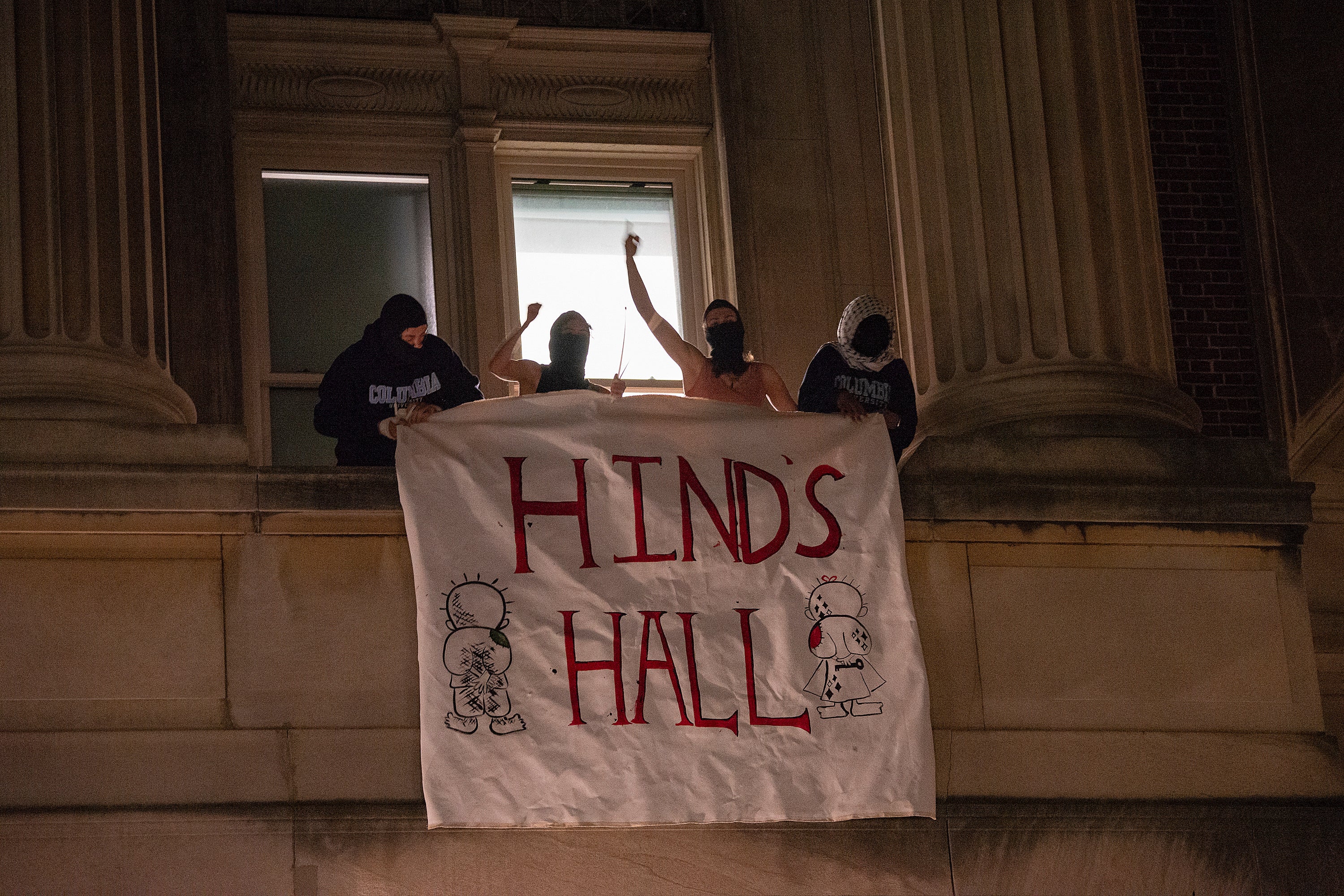 Gaza protesters hang a banner that reads ‘Hind’s Hall’ as they barricade themselves inside Columbia University’s Hamilton Hall