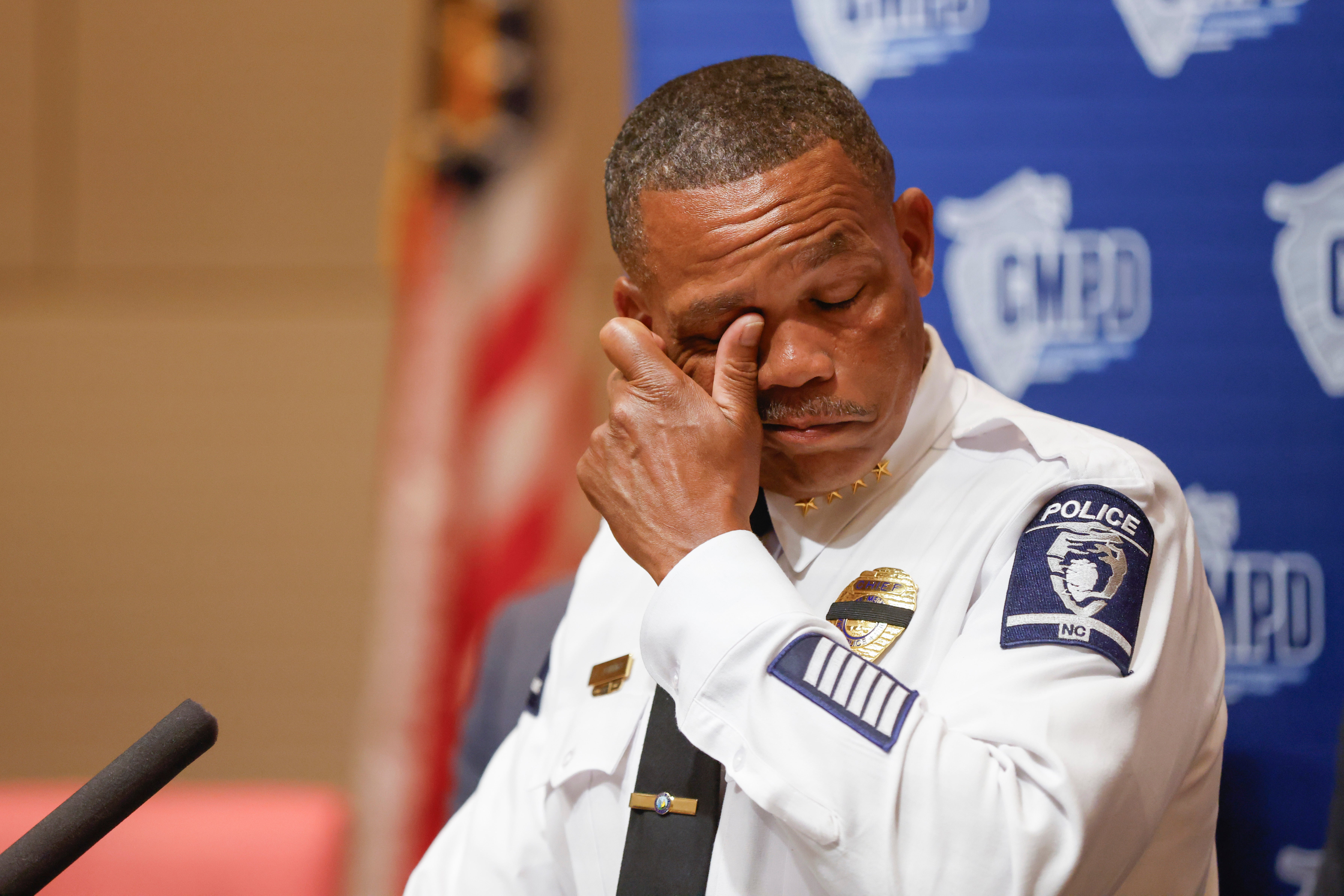 CMPD Chief Johnny Jennings wiping away tears at a press conference