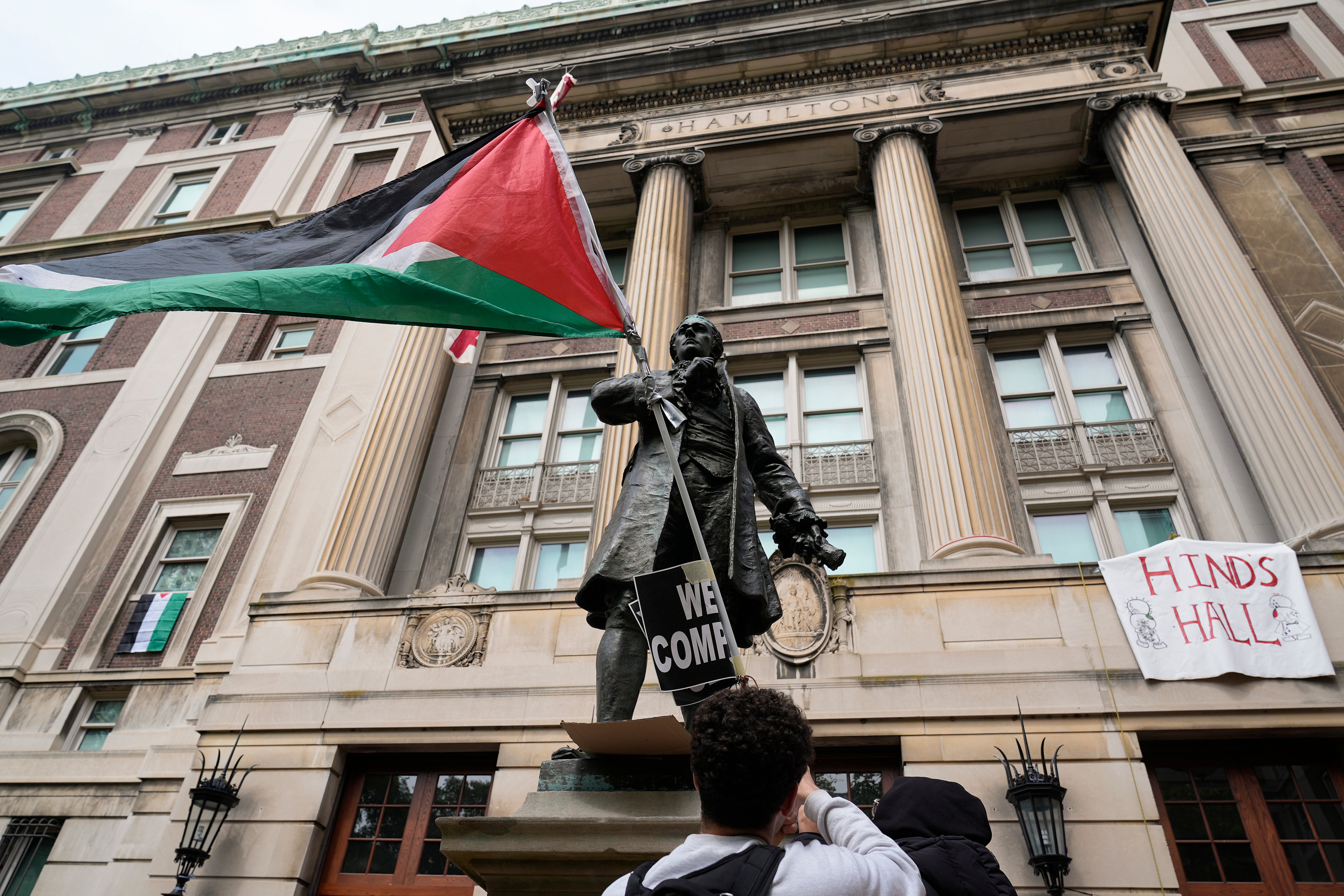 A student protester parades a Palestinian flag outside the entrance to Hamilton Hall. Pro-Palestinian protesters occupied the building on Columbia University’s campus early Tuesday morning