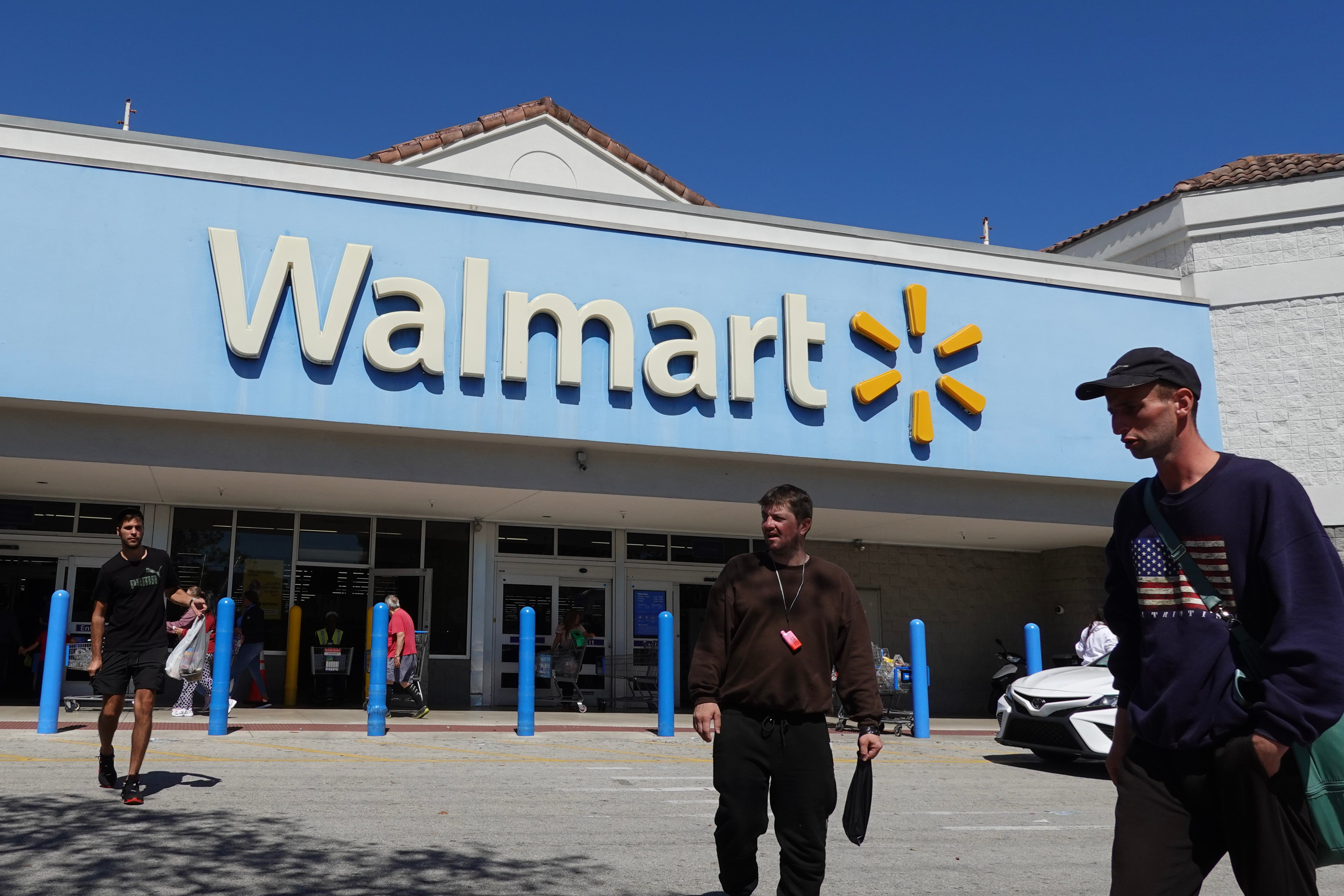 People walk near the entrance to a Walmart Supercenter on February 20, 2024, in Hallandale Beach, Florida.
