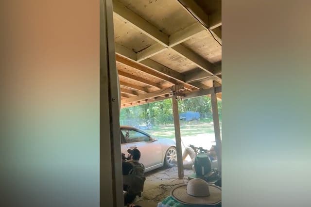 Footage from a resident shows two police officers hiding behind a car as they engage in a shootout with an armed suspect in Charlotte, North Carolina