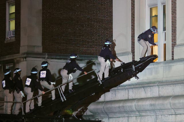 NYPD officers in riot gear break into a building at Columbia University, where pro-Palestinian students are barricaded inside a building and have set up an encampment, in New York City on April 30, 2024