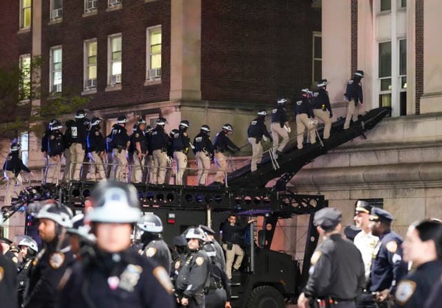 <p>NYPD officers in riot gear break into a building at Columbia University, where pro-Palestinian students are barricaded inside a building and have set up an encampment, in New York City on April 30, 2024</p>