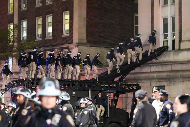 New York City police officers use a ramp on an armored vehicle to enter Hamilton Hall at Columbia University after pro-Palestinian protestors barricaded themselves in the building earlier in the day in New York, New York
