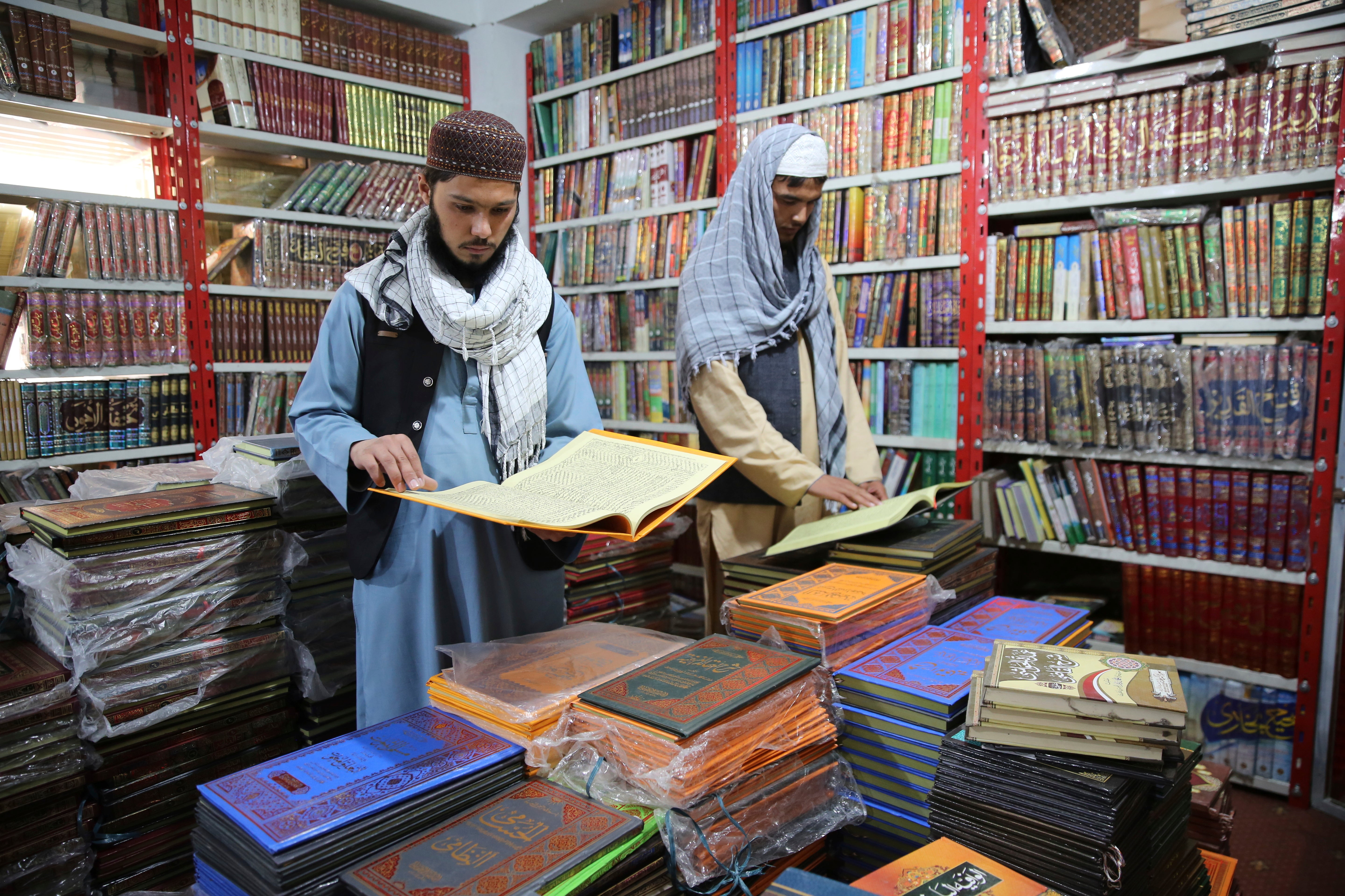 Afghans read books in a specialized religious bookstore in Kabul, Afghanistan