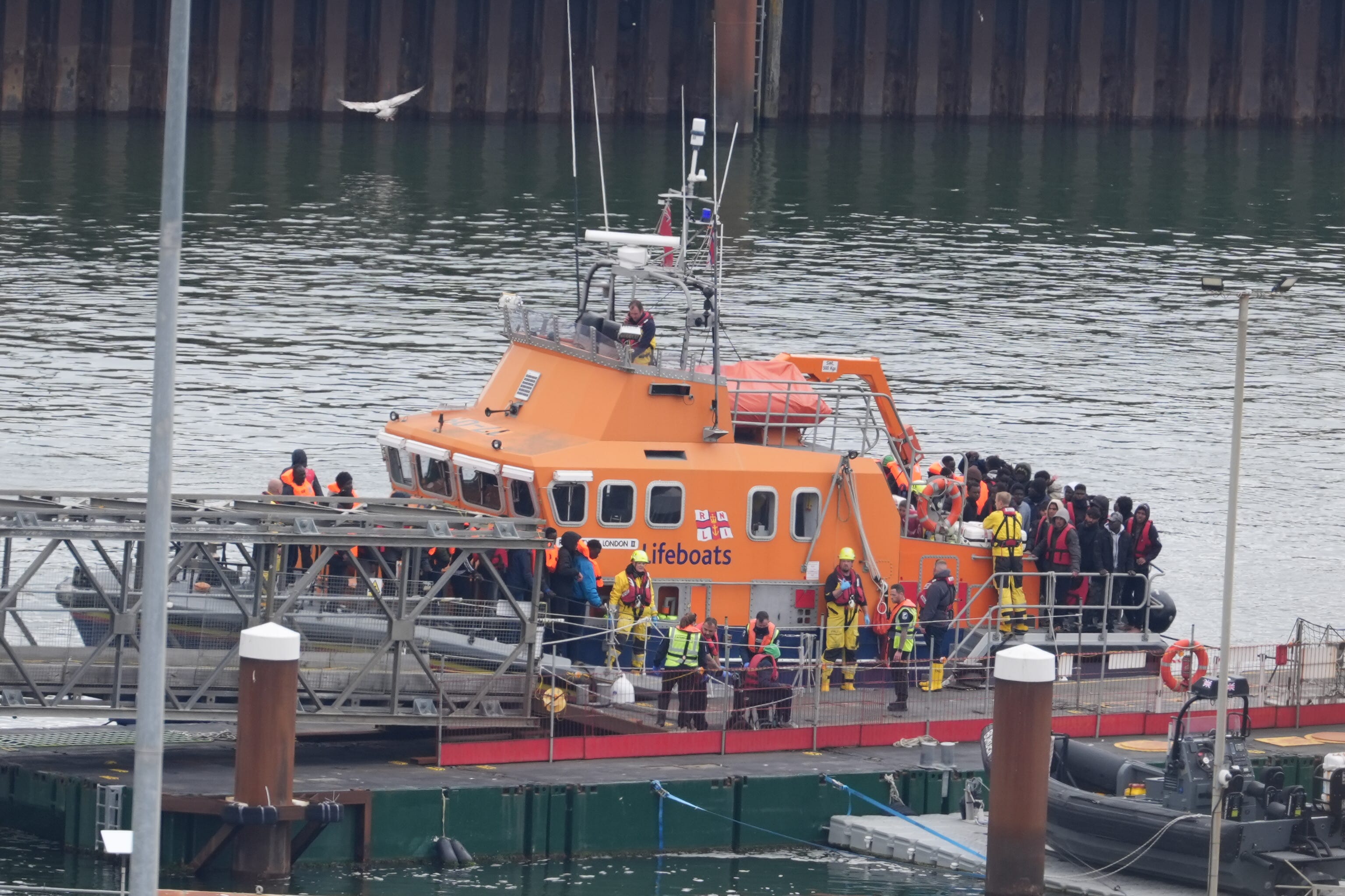 A group of people thought to be migrants are brought in to Dover (PA)