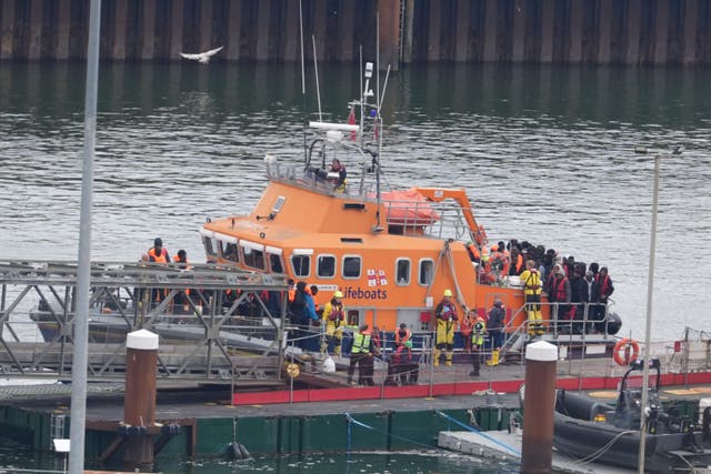 A group of people thought to be migrants are brought in to Dover (PA)