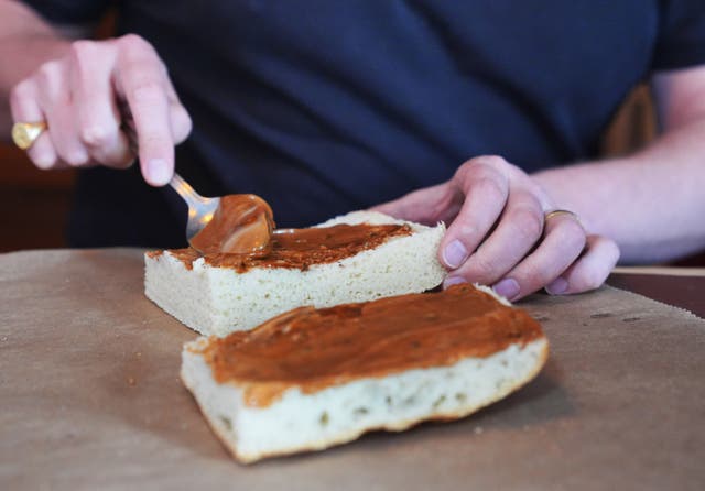 <p>Max Halley spreading vegan mayonnaise on bread</p>