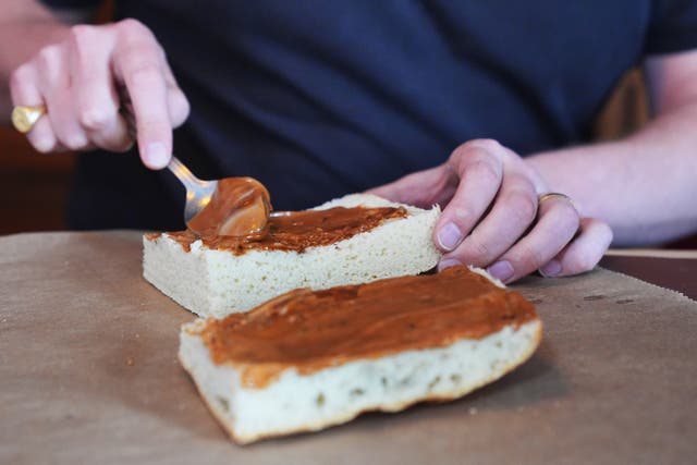 <p>Max Halley spreading vegan mayonnaise on bread</p>