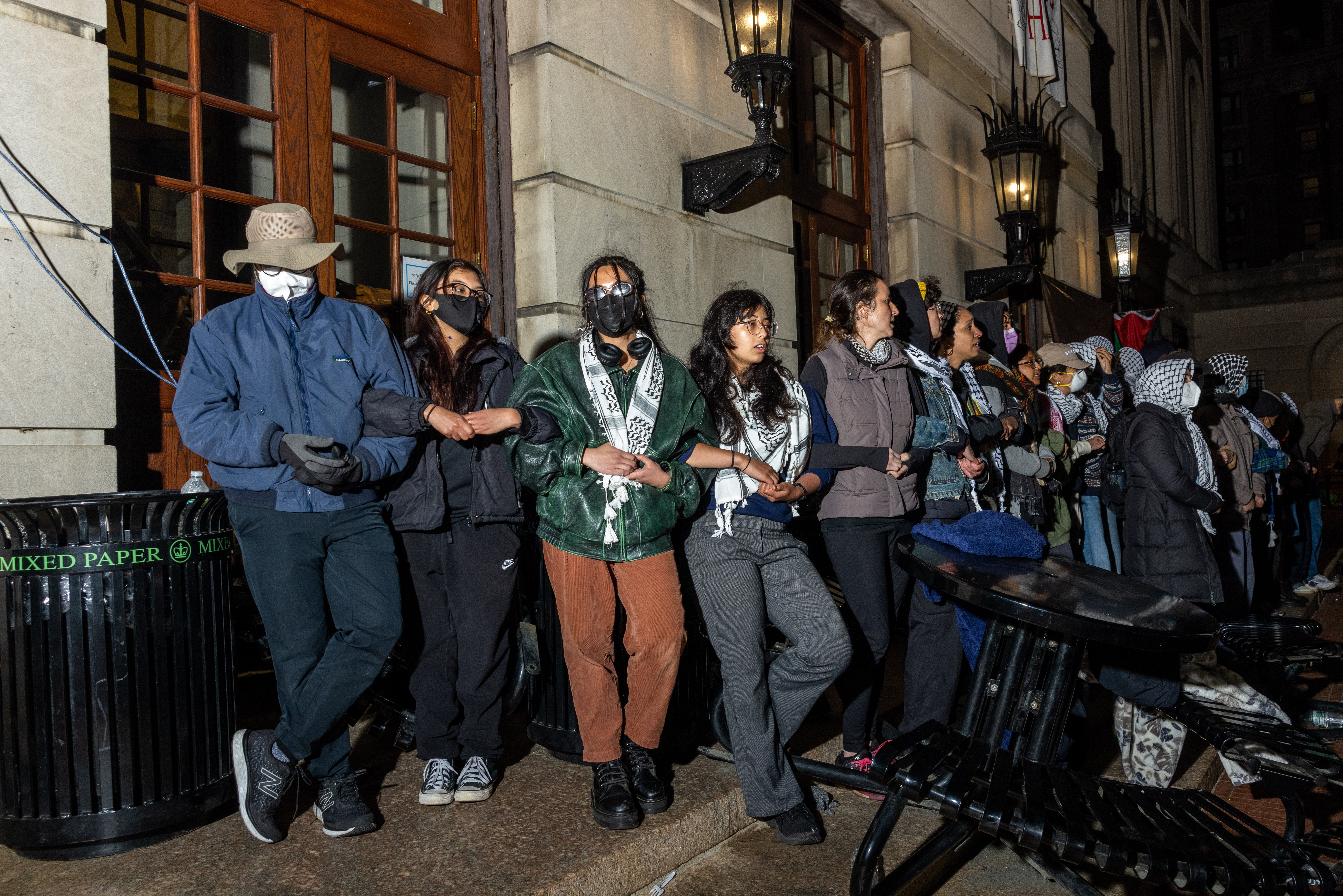 Demonstrators link arms to protect their fellow protestors barricaded inside Hamilton Hall on Tuesday evening