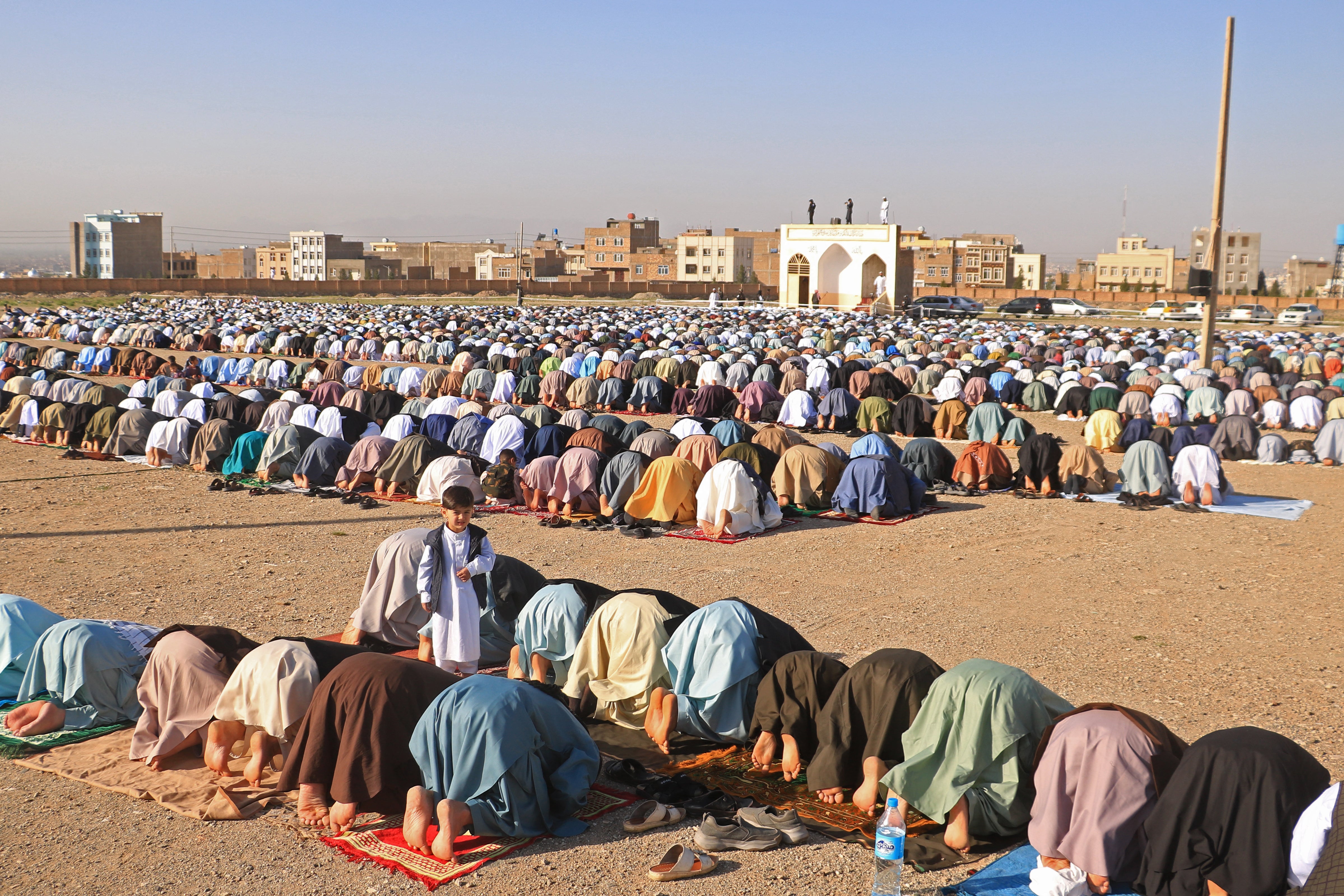 Muslim devotees offer Eid al-Fitr prayers, which marks the end of the holy fasting month of Ramadan at the Guzargah mosque on 10 April