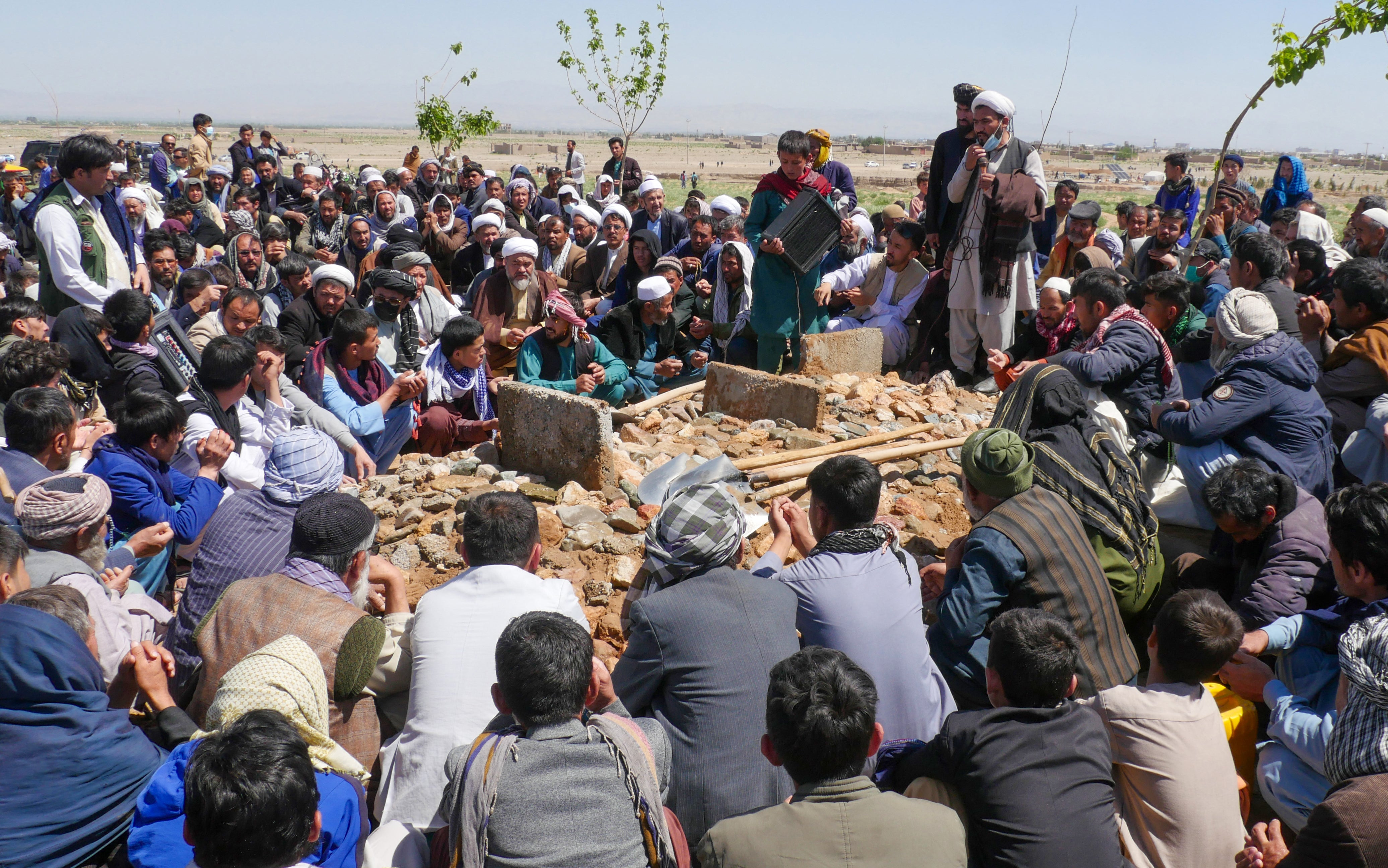 Afghans mourn at a burial ceremony of the slain Shiite Muslims after gunmen attacked a mosque in Guzara district of Herat province