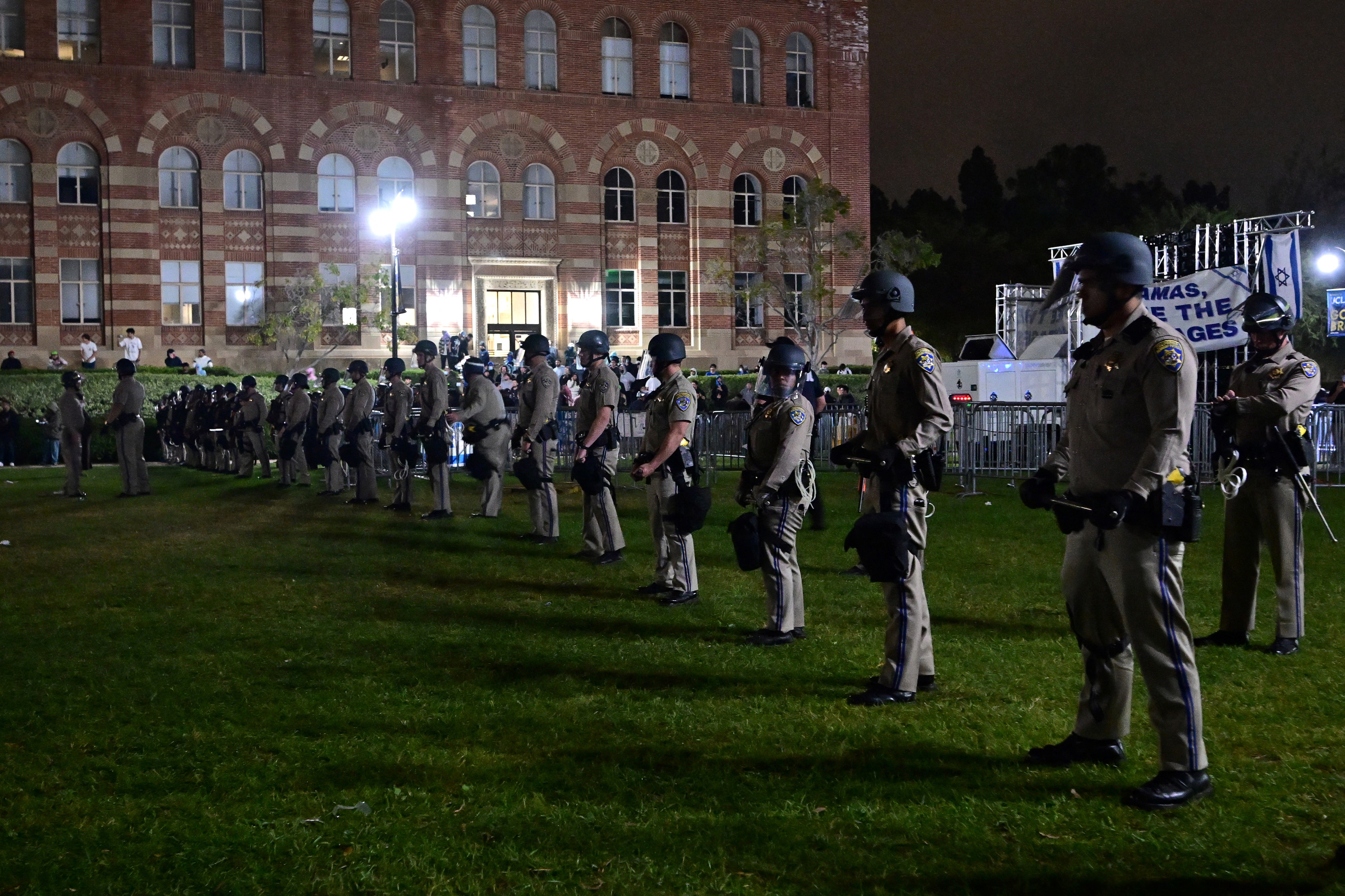US Police officers stand guard after clashes errupted on the campus of the University of California Los Angeles (UCLA)