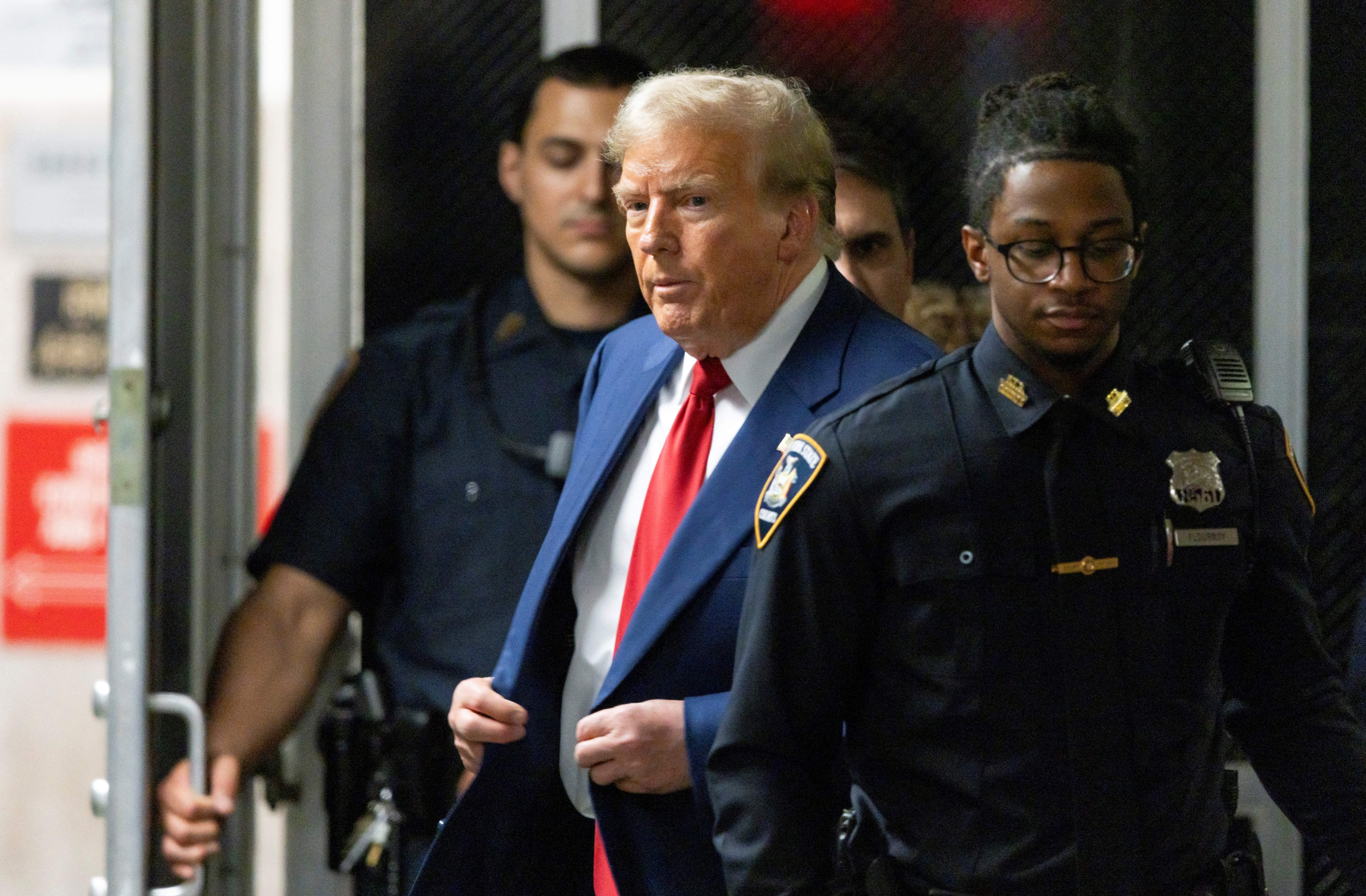 Former US president Donald Trump walks out of court to speak to the press during a break in his trial at Manhattan Criminal Court on 30 April 2024