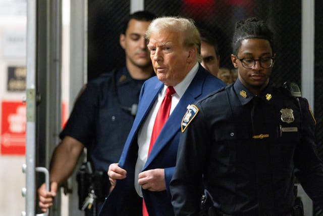 <p>Former US president Donald Trump walks out of court to speak to the press during a break in his trial at Manhattan Criminal Court on 30 April 2024</p>